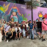 Comuna 13 tour group standing next to street art