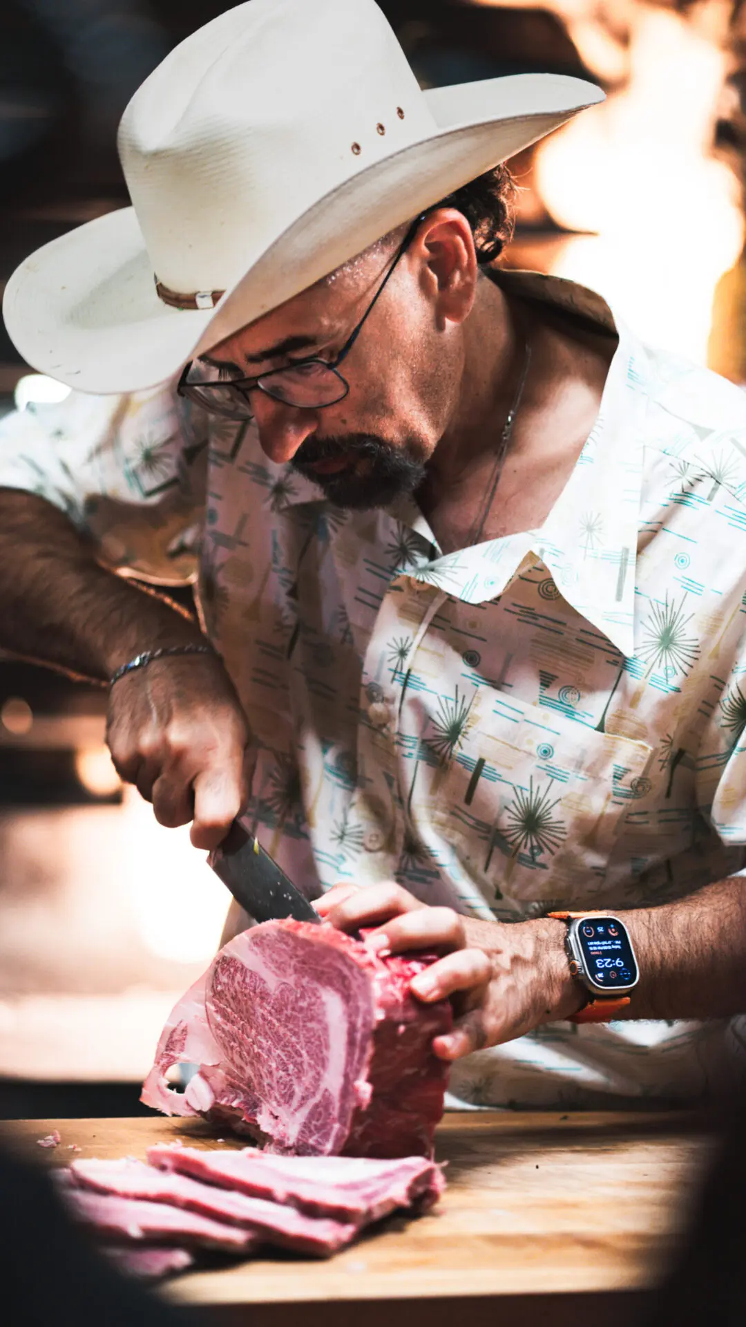 Butcher slicing a piece of meat with precision.