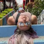 Woman laying upside down on a staircase