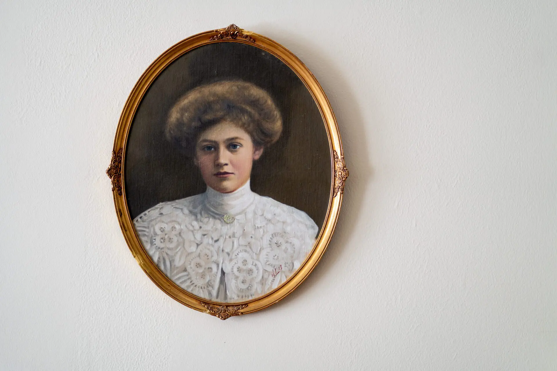 Portrait of a woman in period clothing framed on the wall