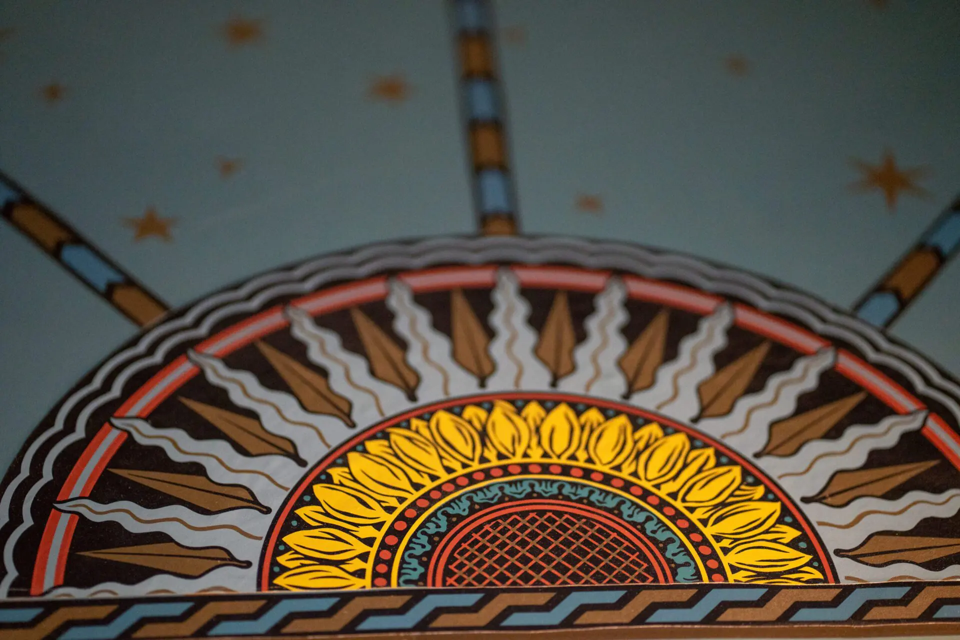 Painted Victorian ceiling with vibrant geometric ornamentation
