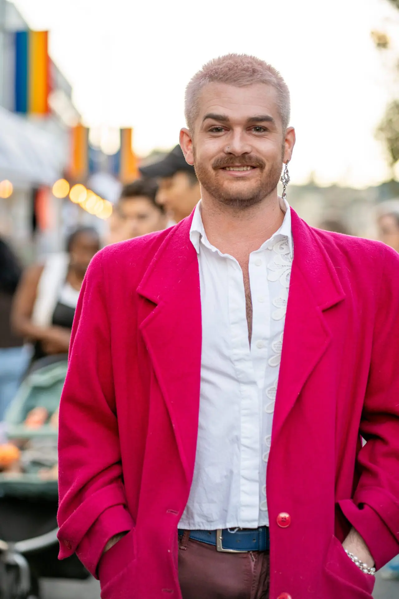 Person in a bold pink jacket smiling at the camera