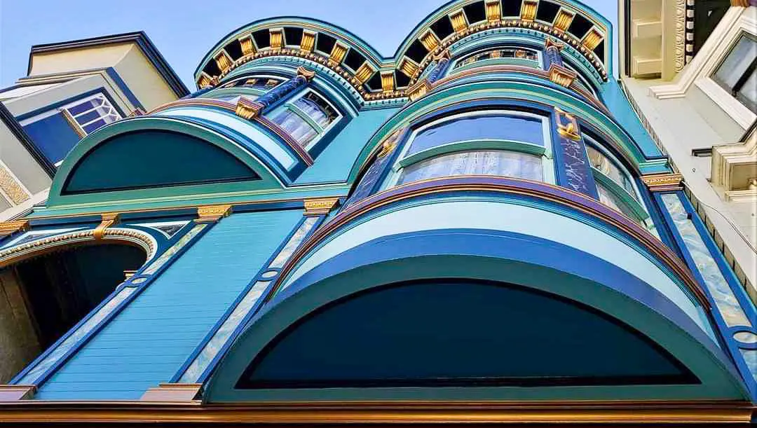Upward view of a Painted Lady with ornate curved windows