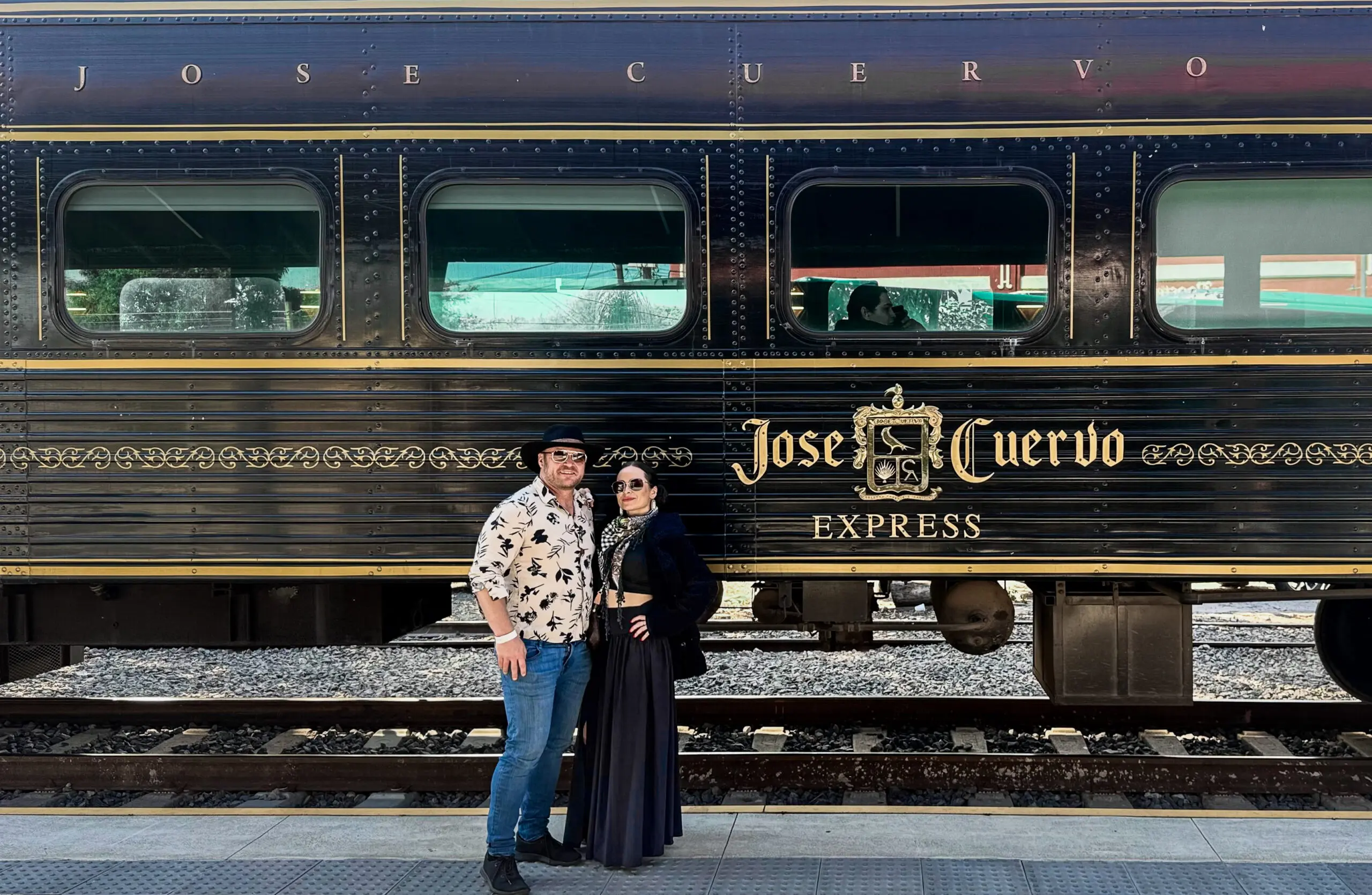 Couple posing in front of the Jose Cuervo Express train.