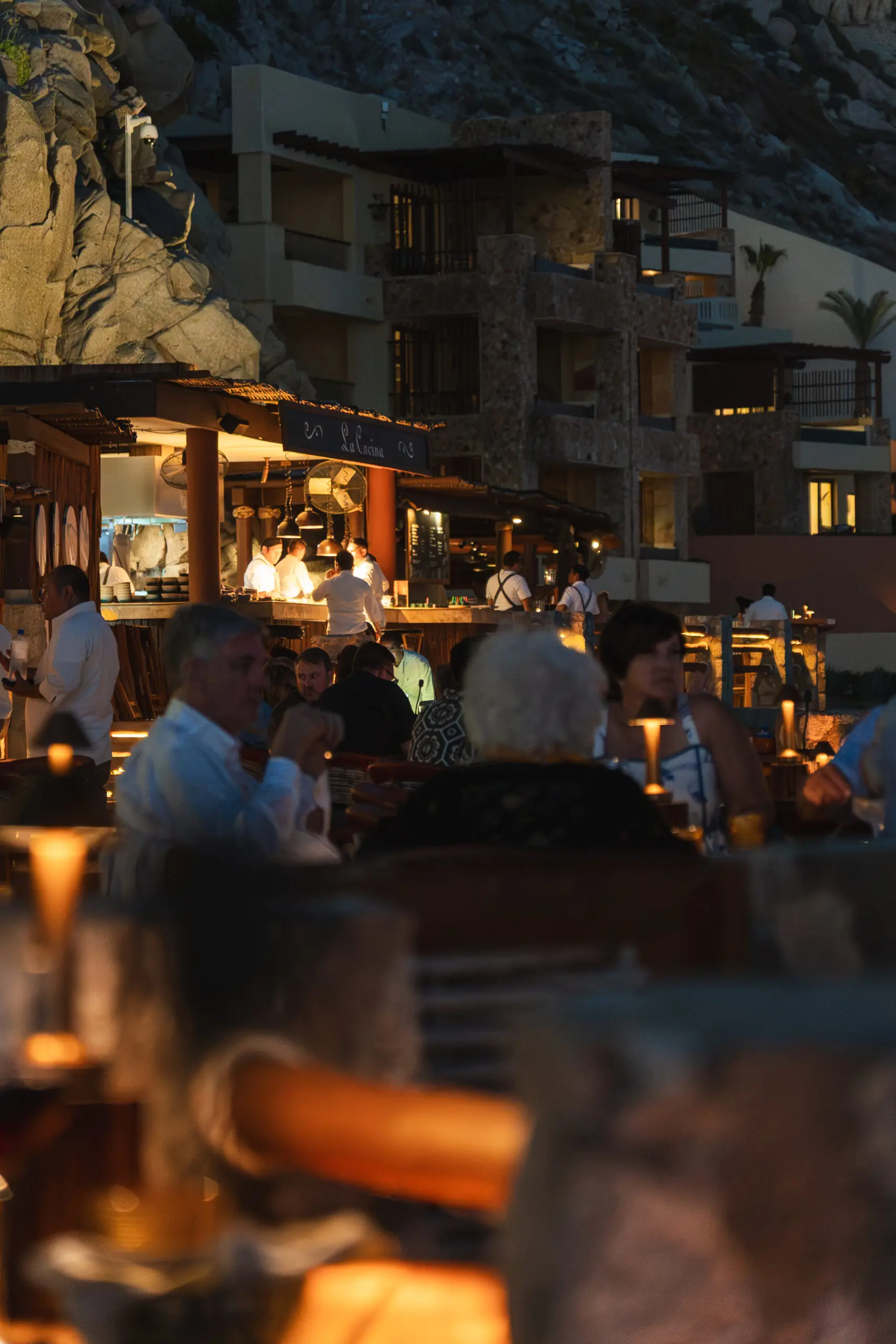 Outdoor evening dining with warm lighting and relaxed atmosphere.