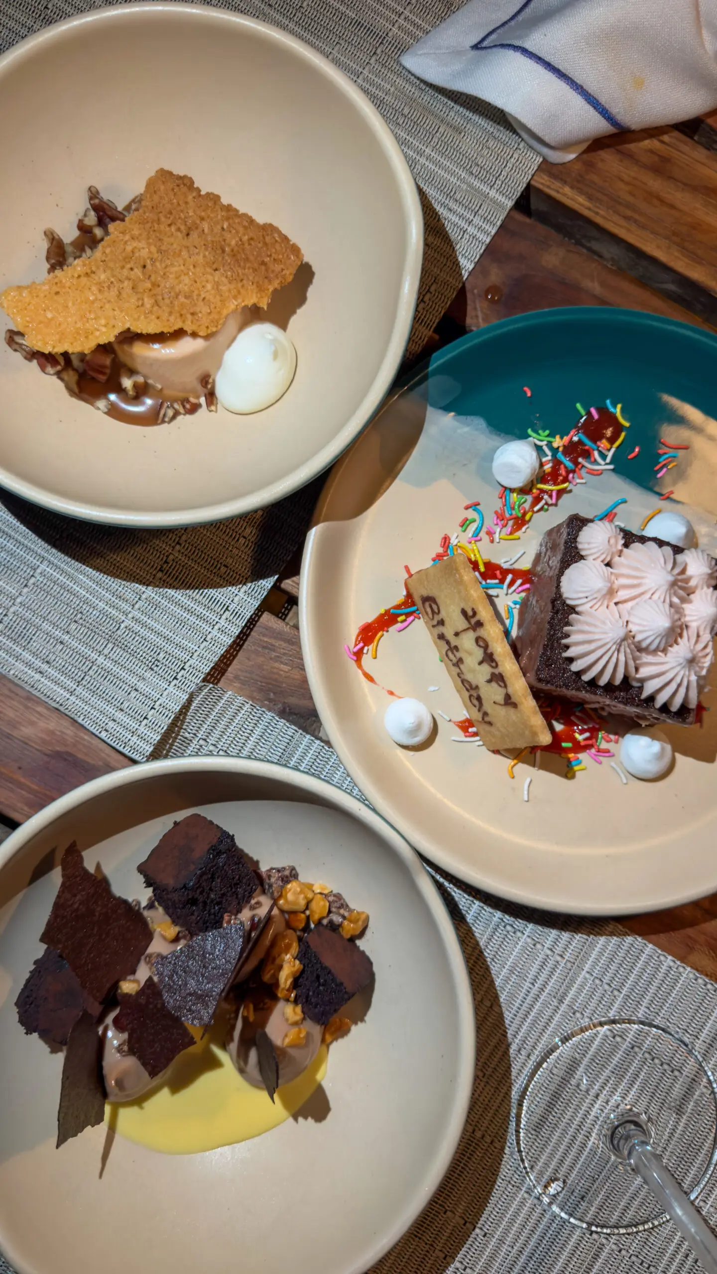 Three dessert plates with various cakes and a scoop of ice cream.