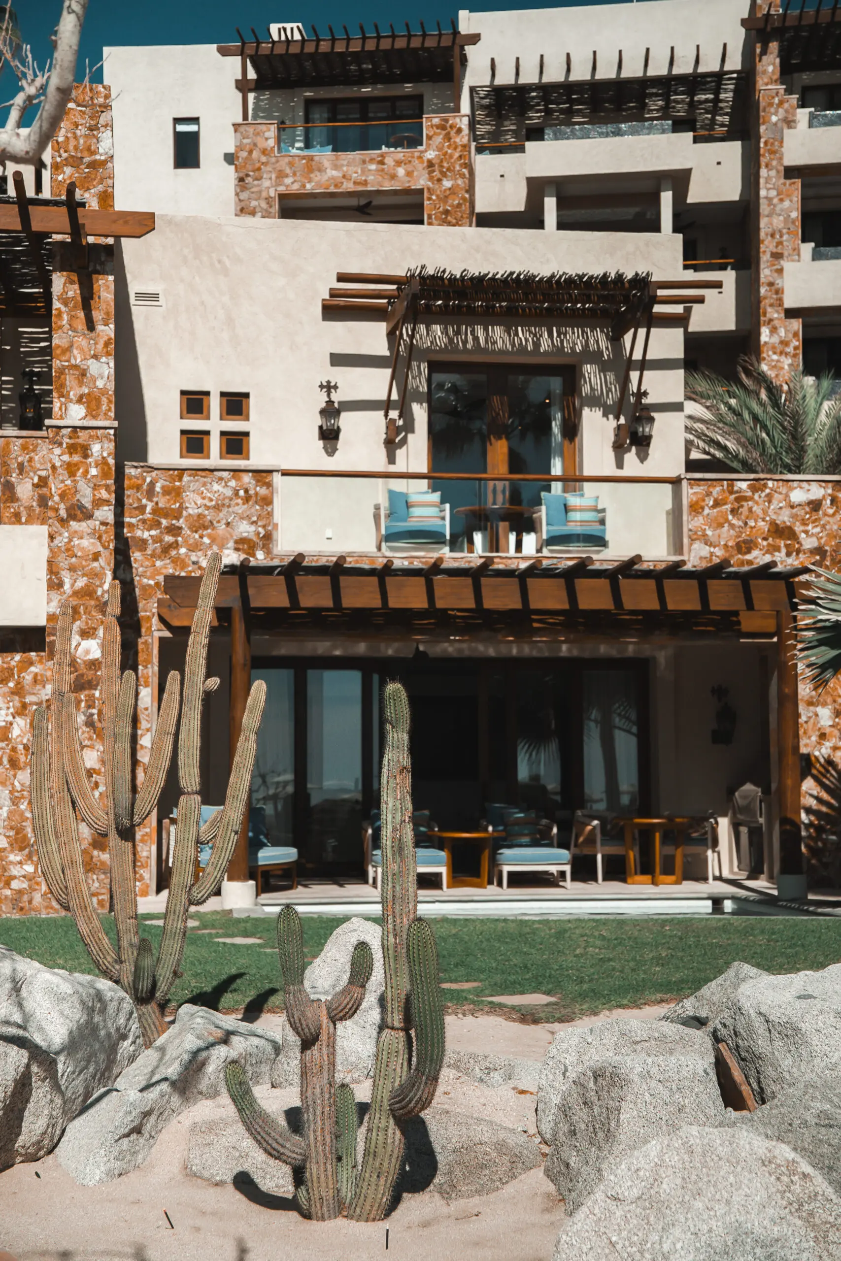 Rustic house with stone walls and a cozy outdoor seating area.