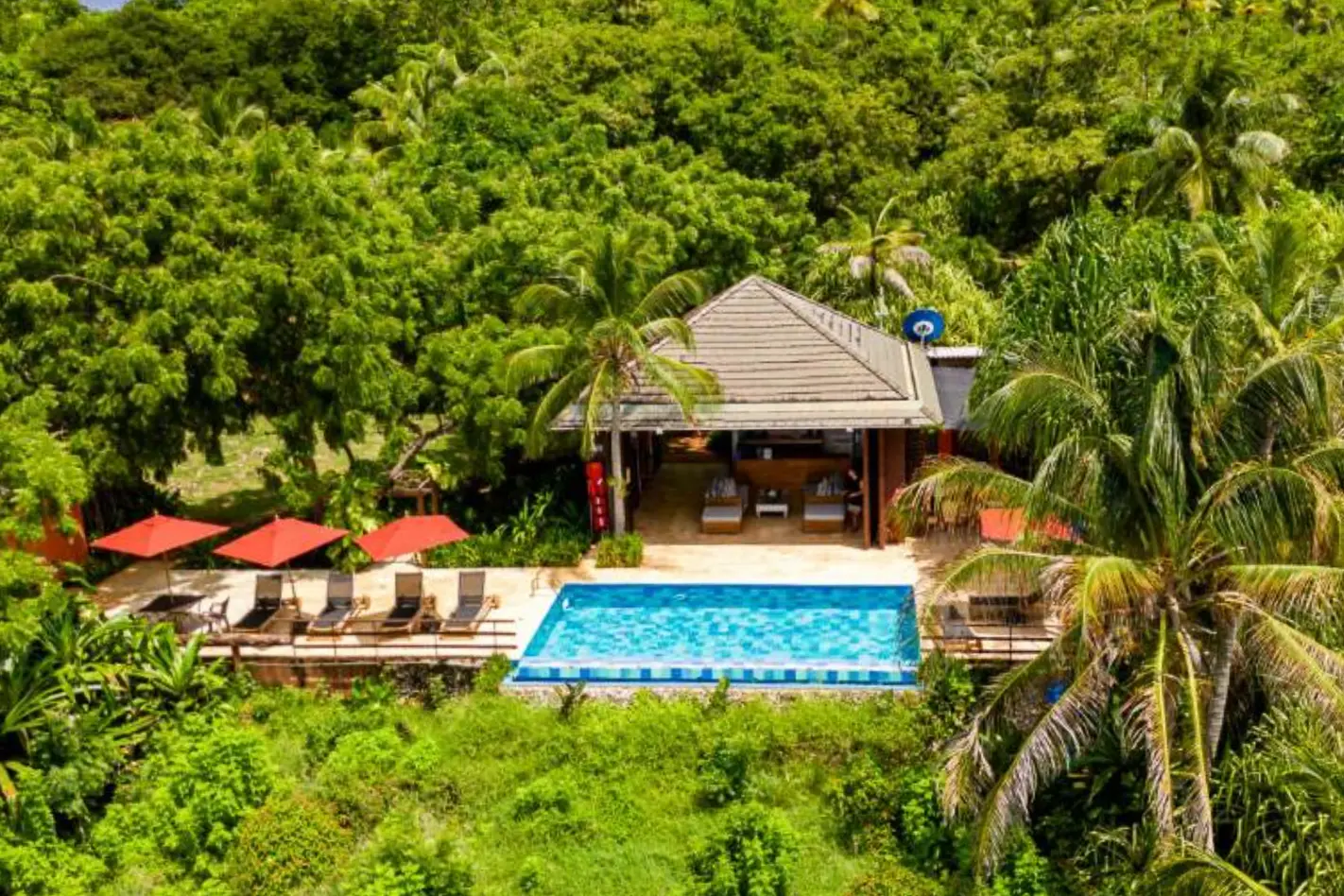 woman with a bob haircut holding a camera up to her face with a light in the background
