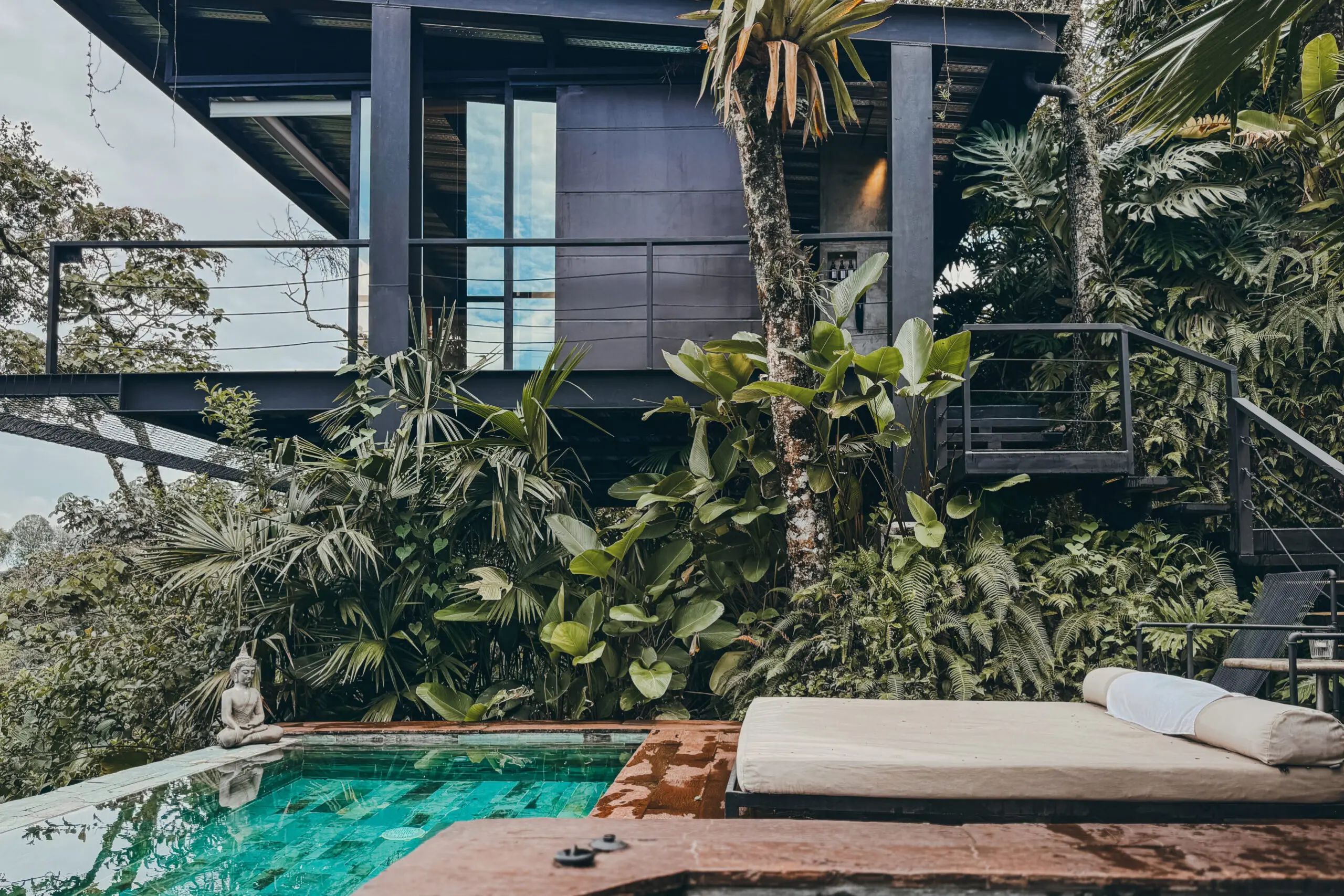 woman with a bob haircut holding a camera up to her face with a light in the background