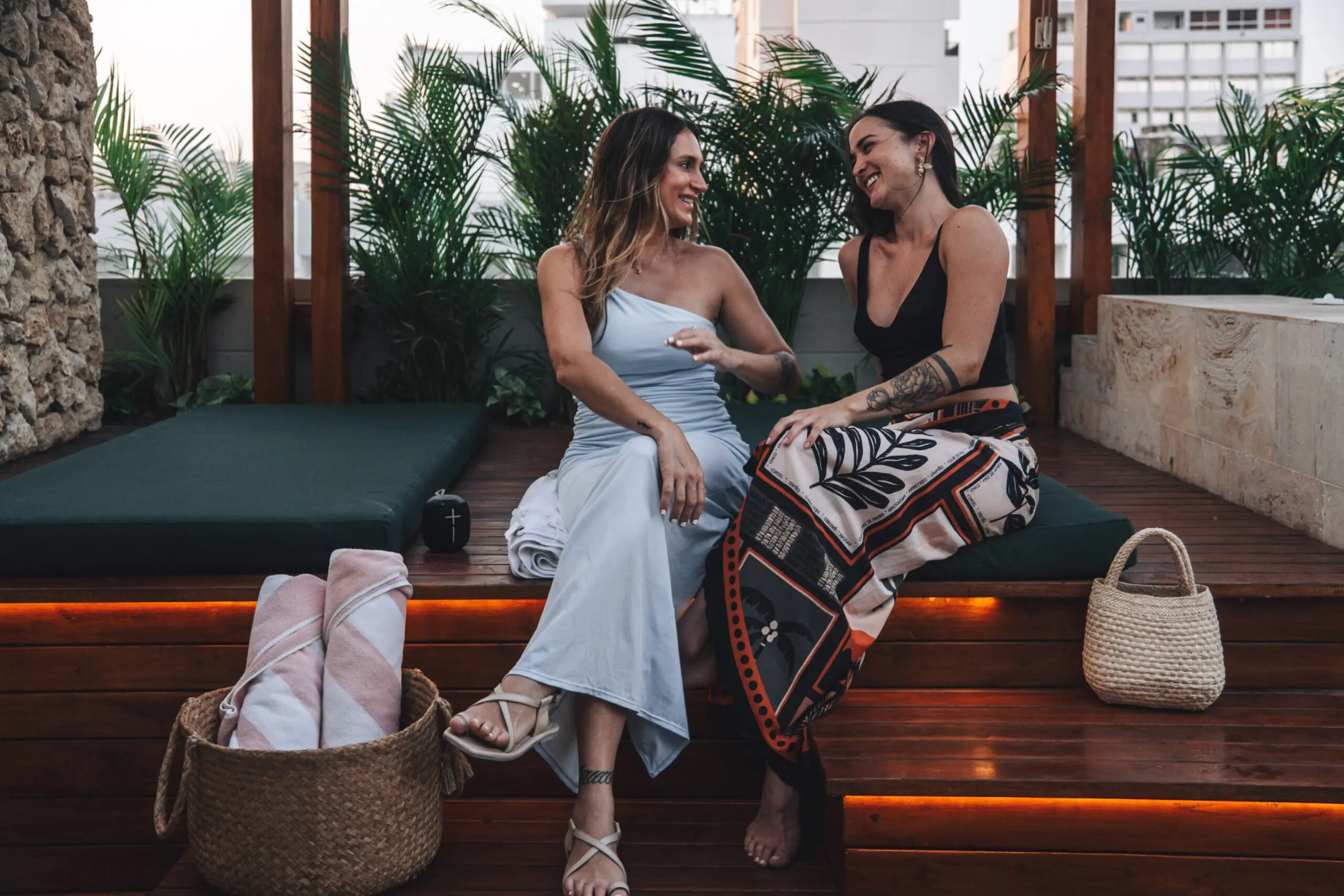 woman with a bob haircut holding a camera up to her face with a light in the background