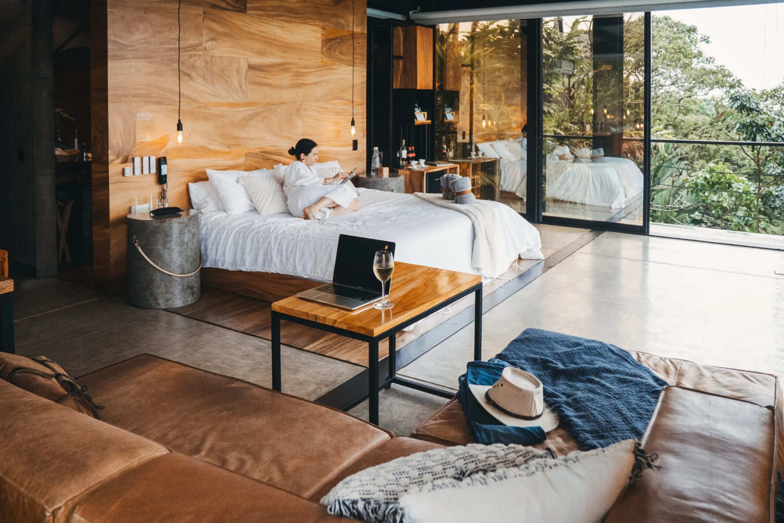 woman with a bob haircut holding a camera up to her face with a light in the background
