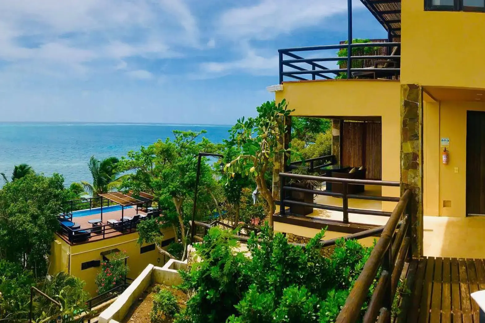 woman with a bob haircut holding a camera up to her face with a light in the background