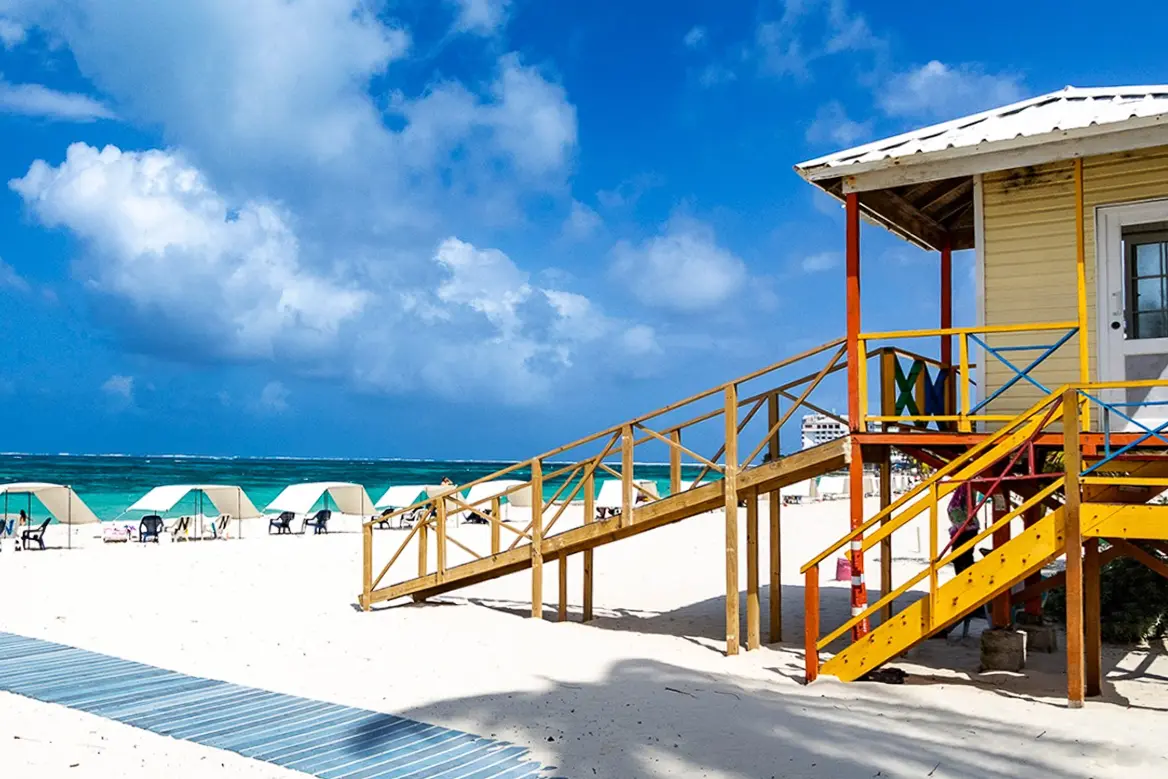 woman with a bob haircut holding a camera up to her face with a light in the background