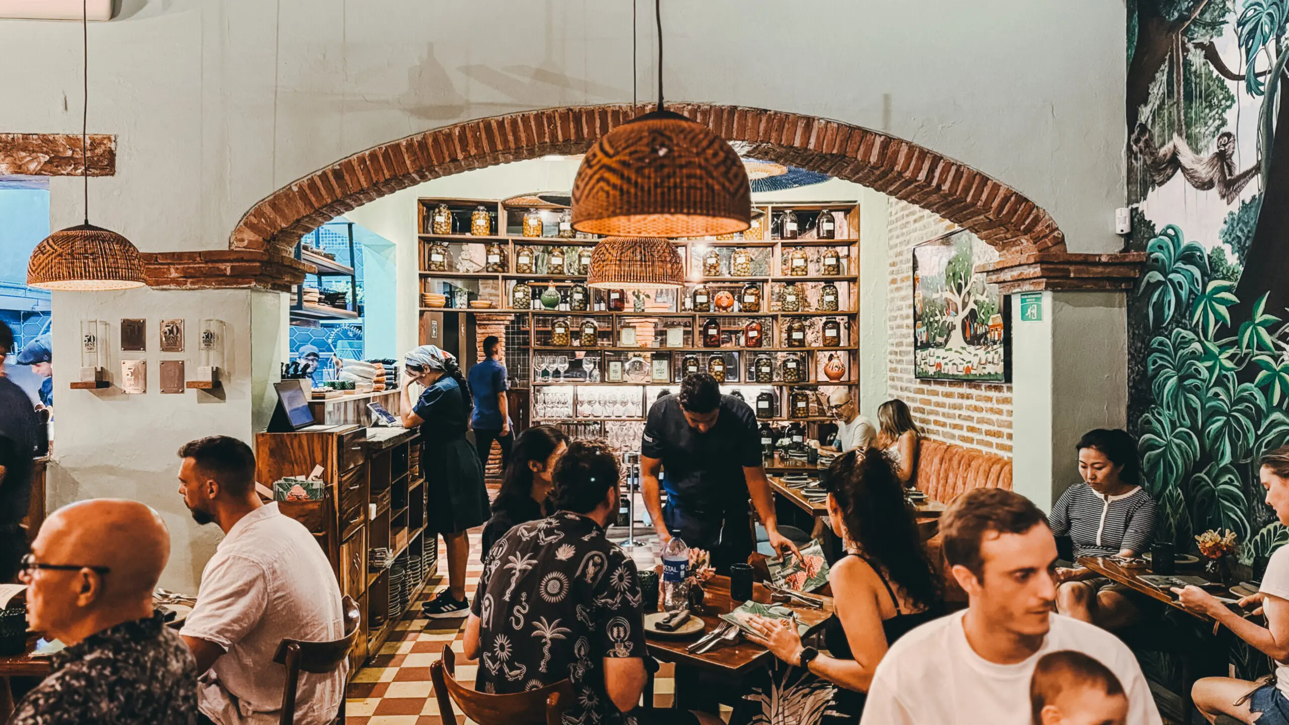 indoor restaurant with jungle plans everywhere, and a Cuban son band playing around a pool