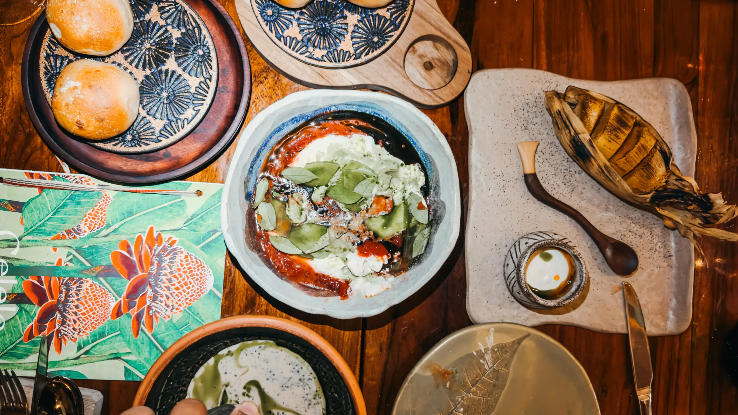 indoor restaurant with jungle plans everywhere, and a Cuban son band playing around a pool
