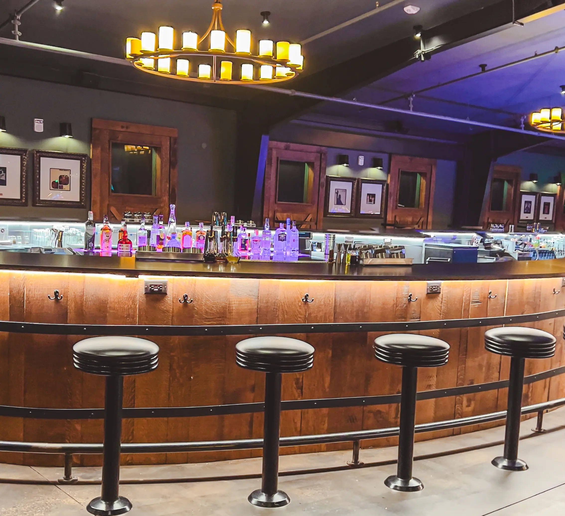 woman with a bob haircut holding a camera up to her face with a light in the background