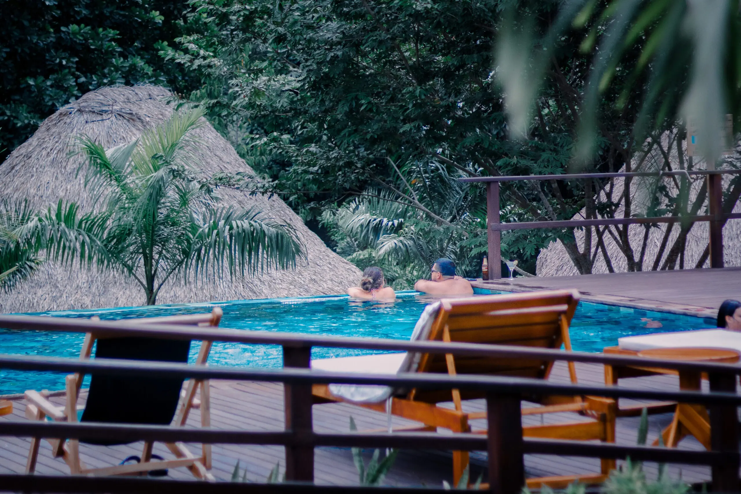 woman with a bob haircut holding a camera up to her face with a light in the background