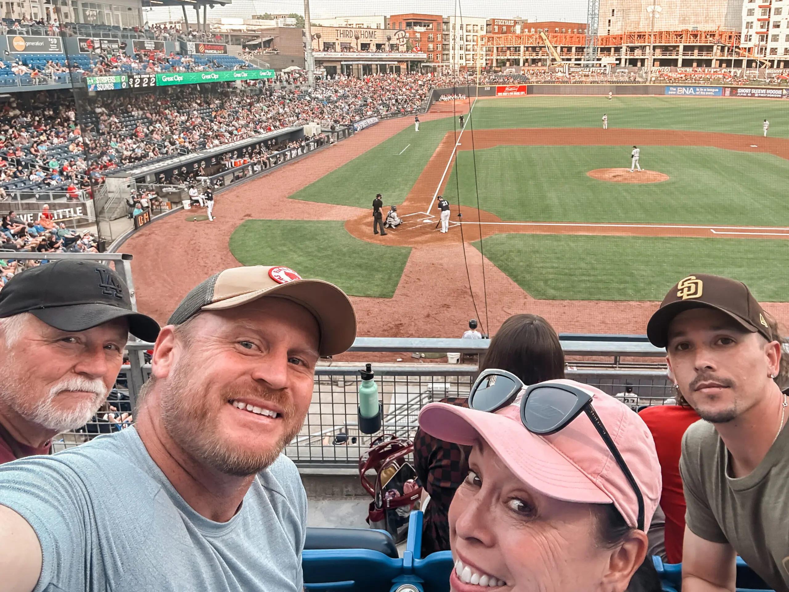 woman with a bob haircut holding a camera up to her face with a light in the background
