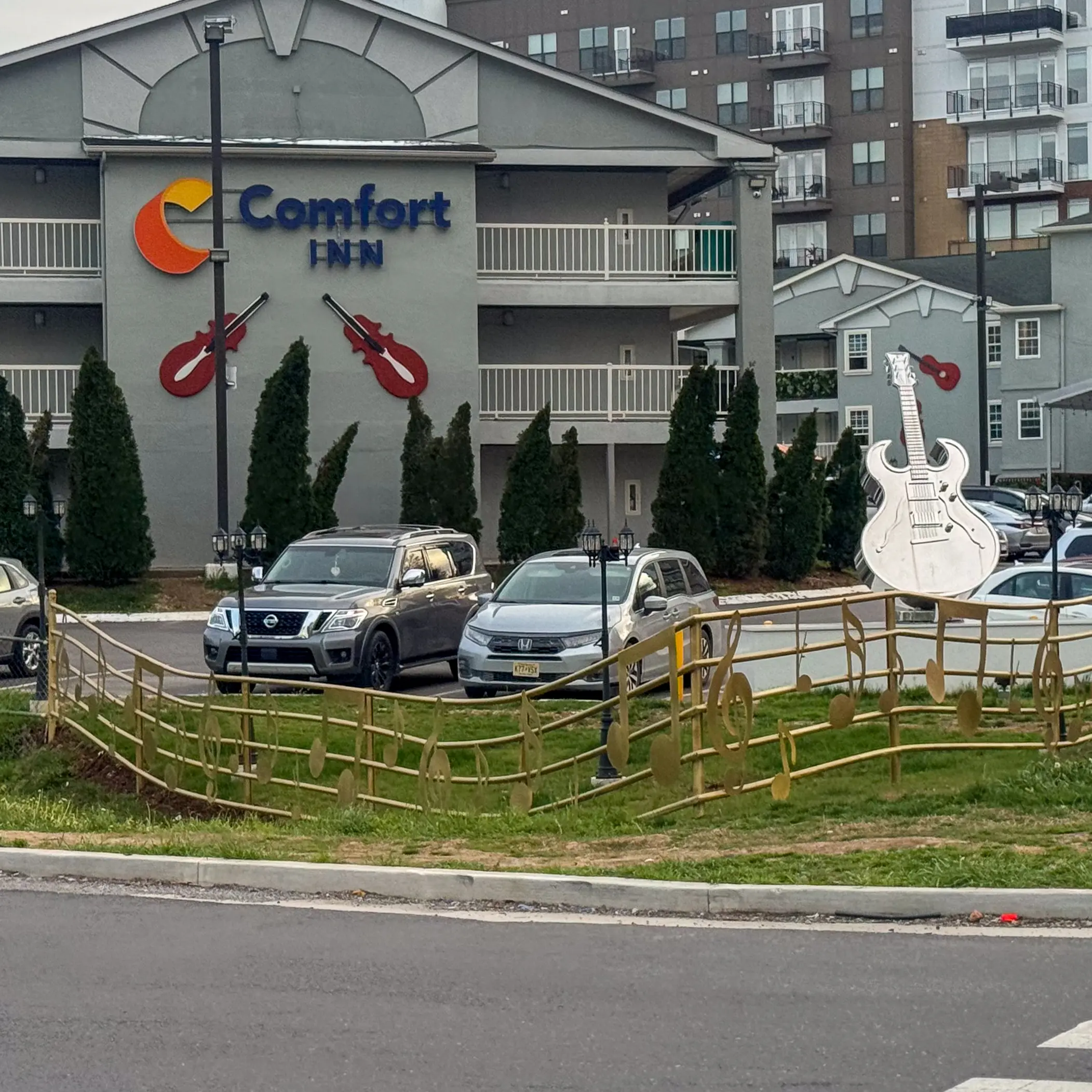 woman with a bob haircut holding a camera up to her face with a light in the background