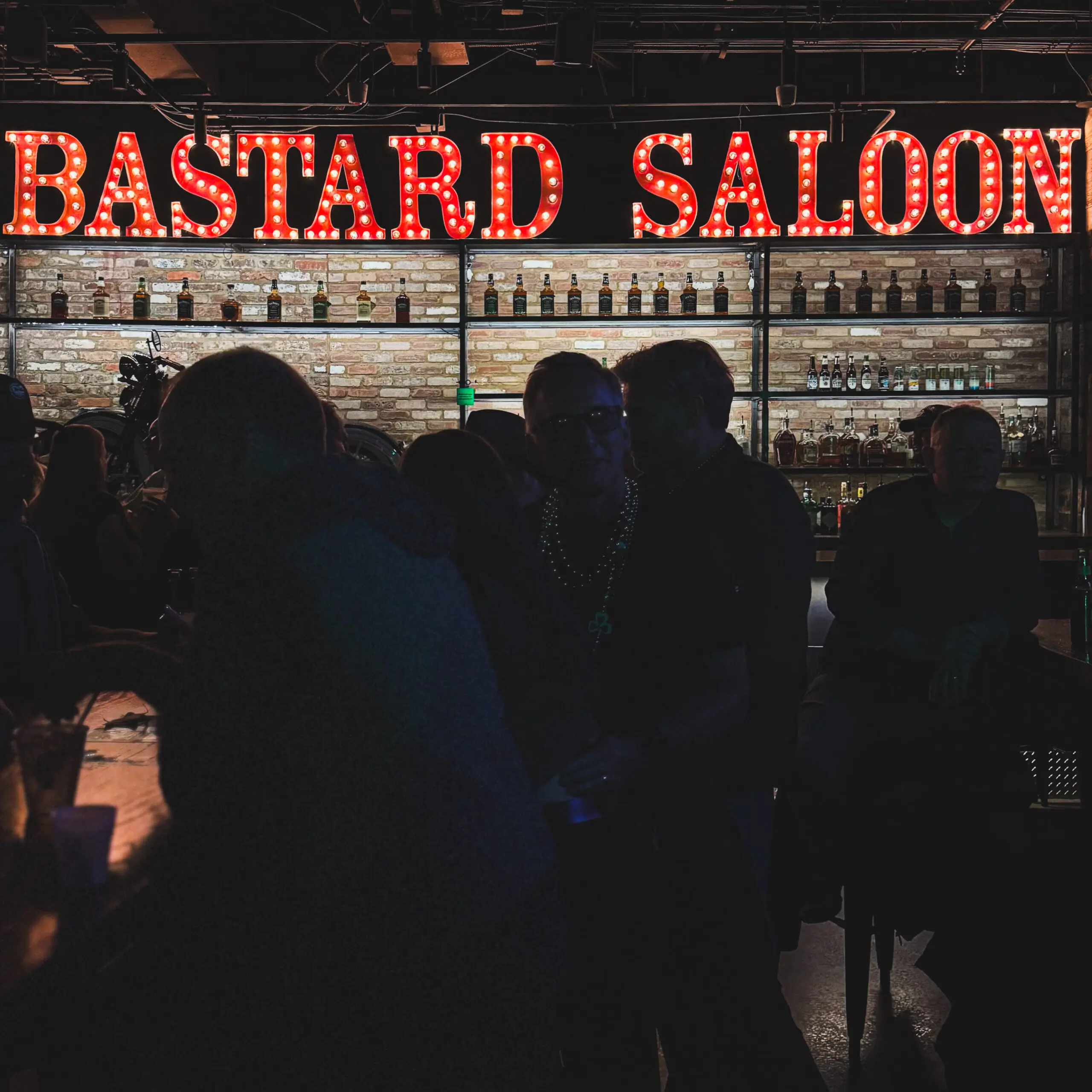 woman with a bob haircut holding a camera up to her face with a light in the background