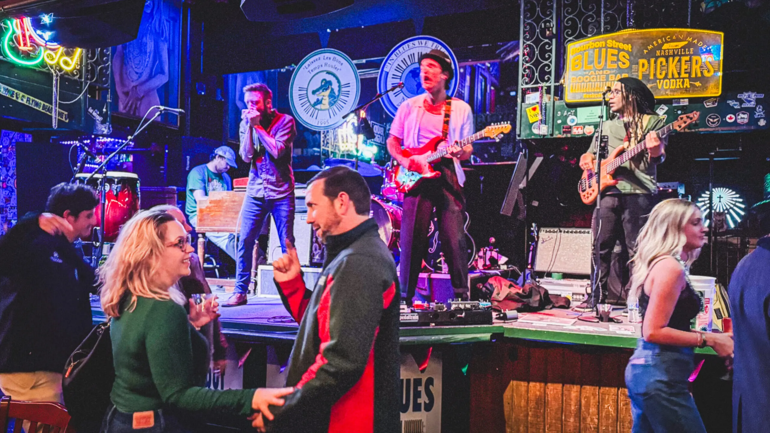 woman with a bob haircut holding a camera up to her face with a light in the background