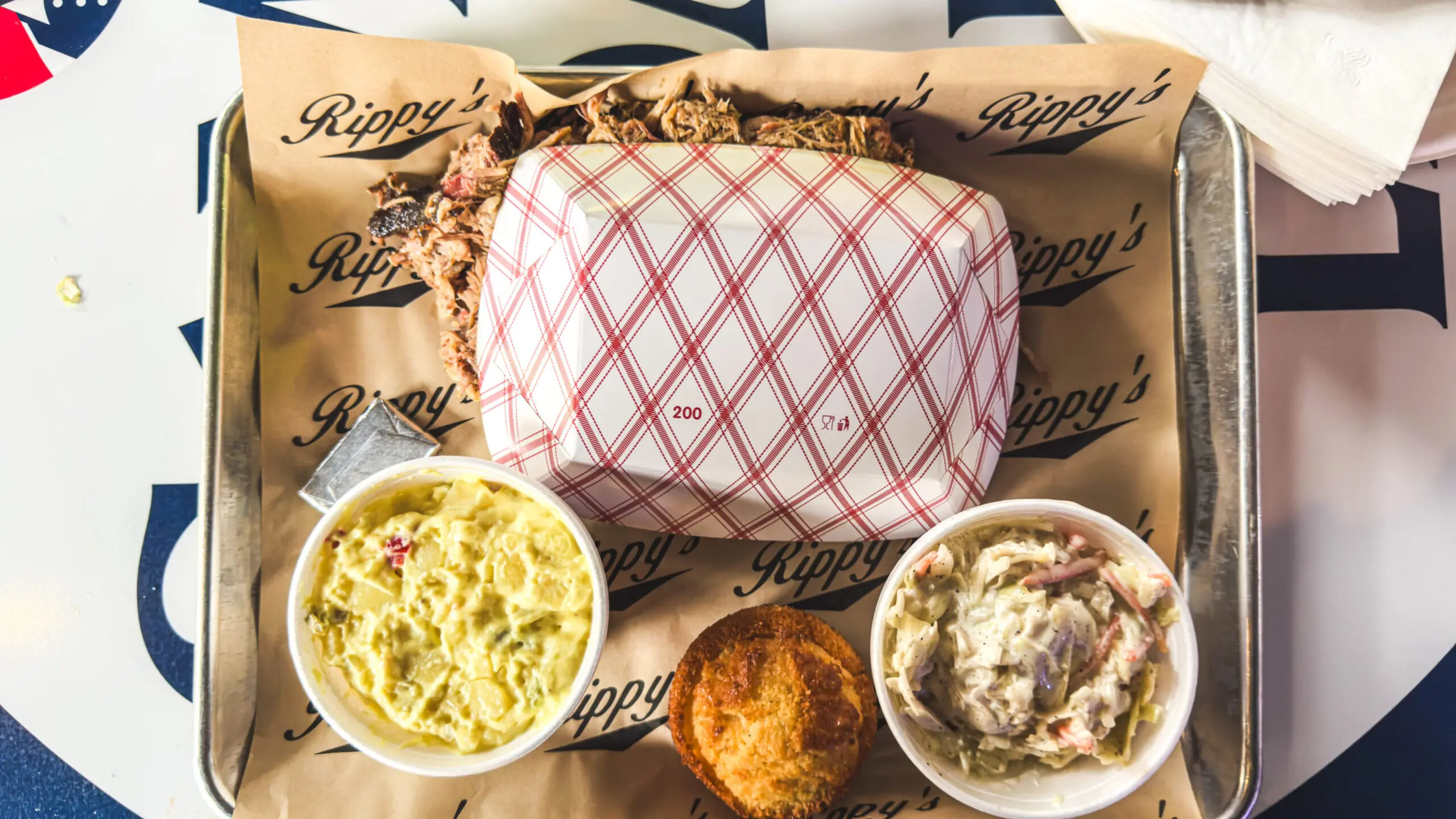 woman with a bob haircut holding a camera up to her face with a light in the background