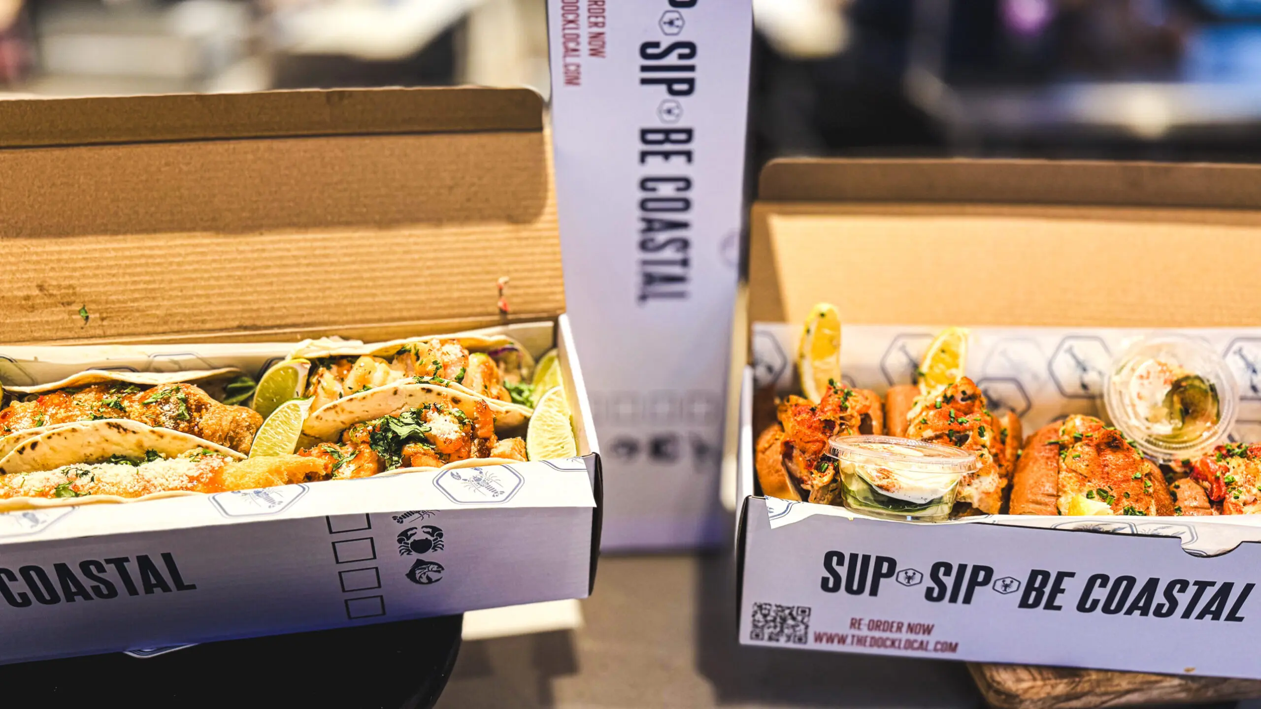 woman with a bob haircut holding a camera up to her face with a light in the background