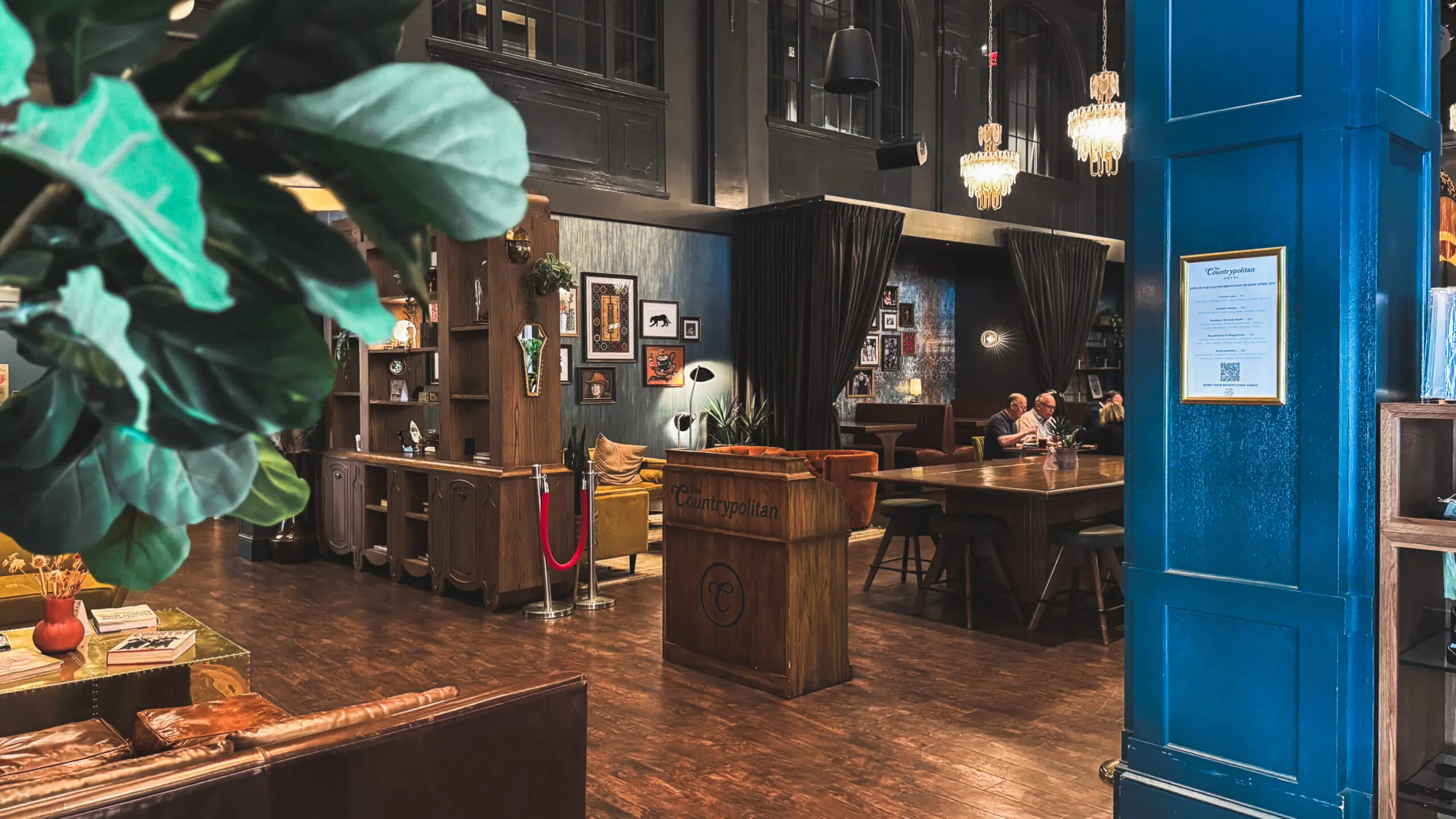 woman with a bob haircut holding a camera up to her face with a light in the background