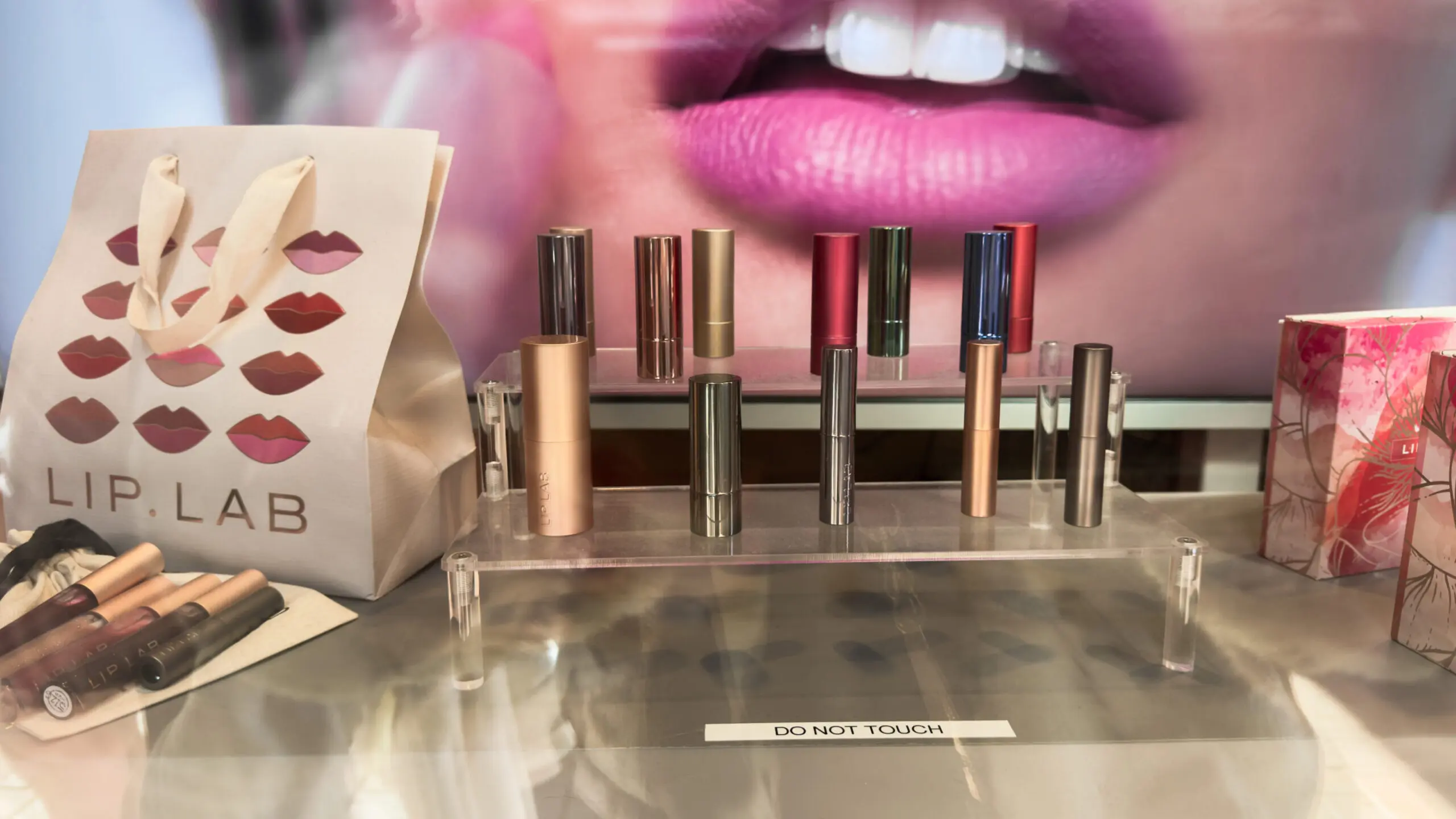 woman with a bob haircut holding a camera up to her face with a light in the background