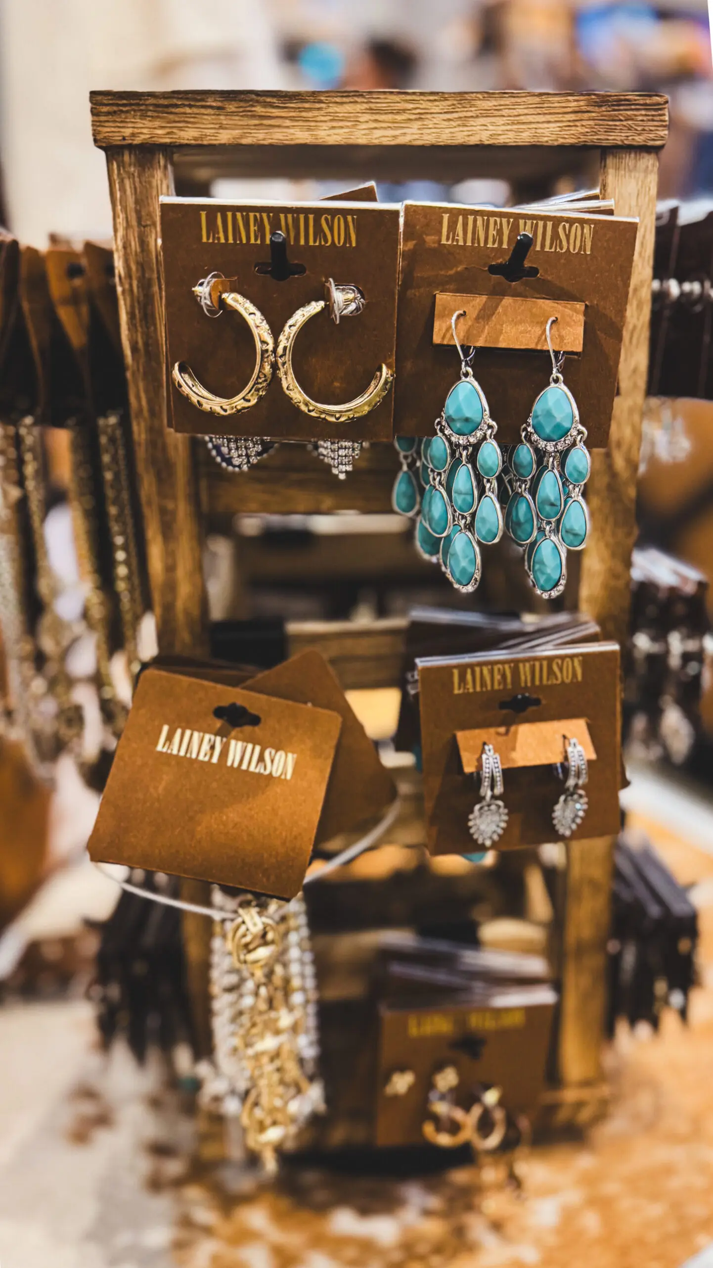 woman with a bob haircut holding a camera up to her face with a light in the background