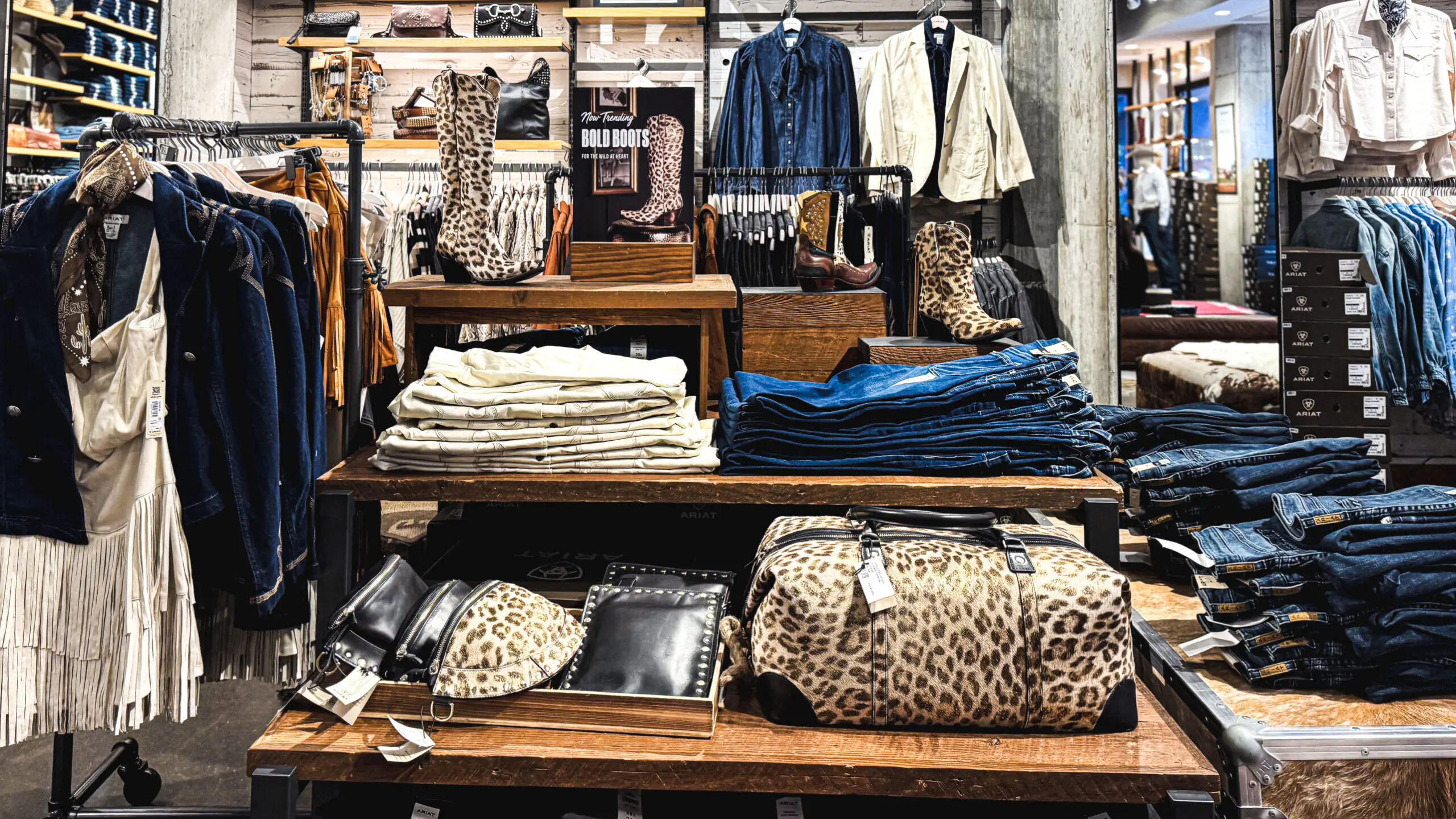 woman with a bob haircut holding a camera up to her face with a light in the background