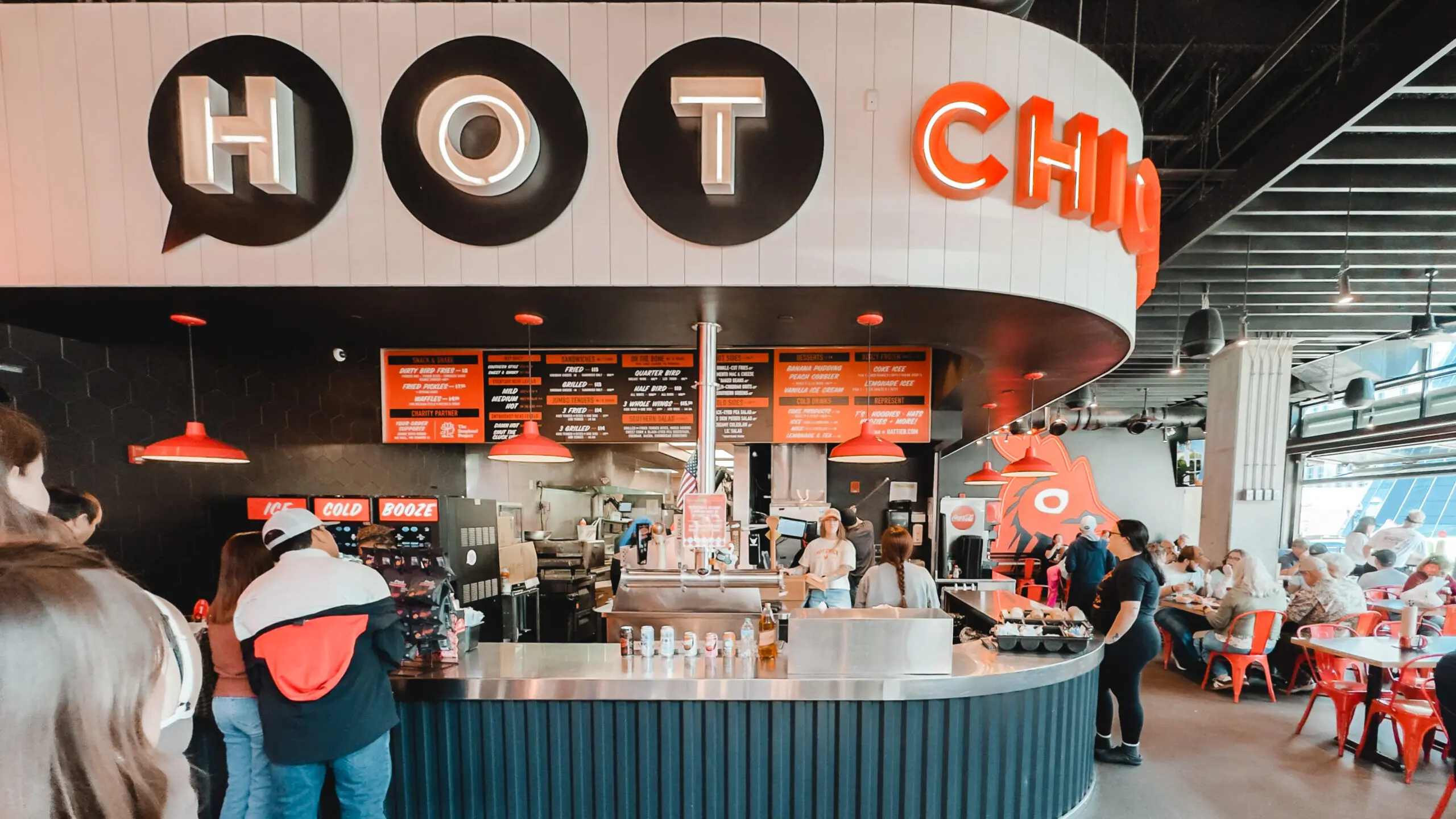 woman with a bob haircut holding a camera up to her face with a light in the background