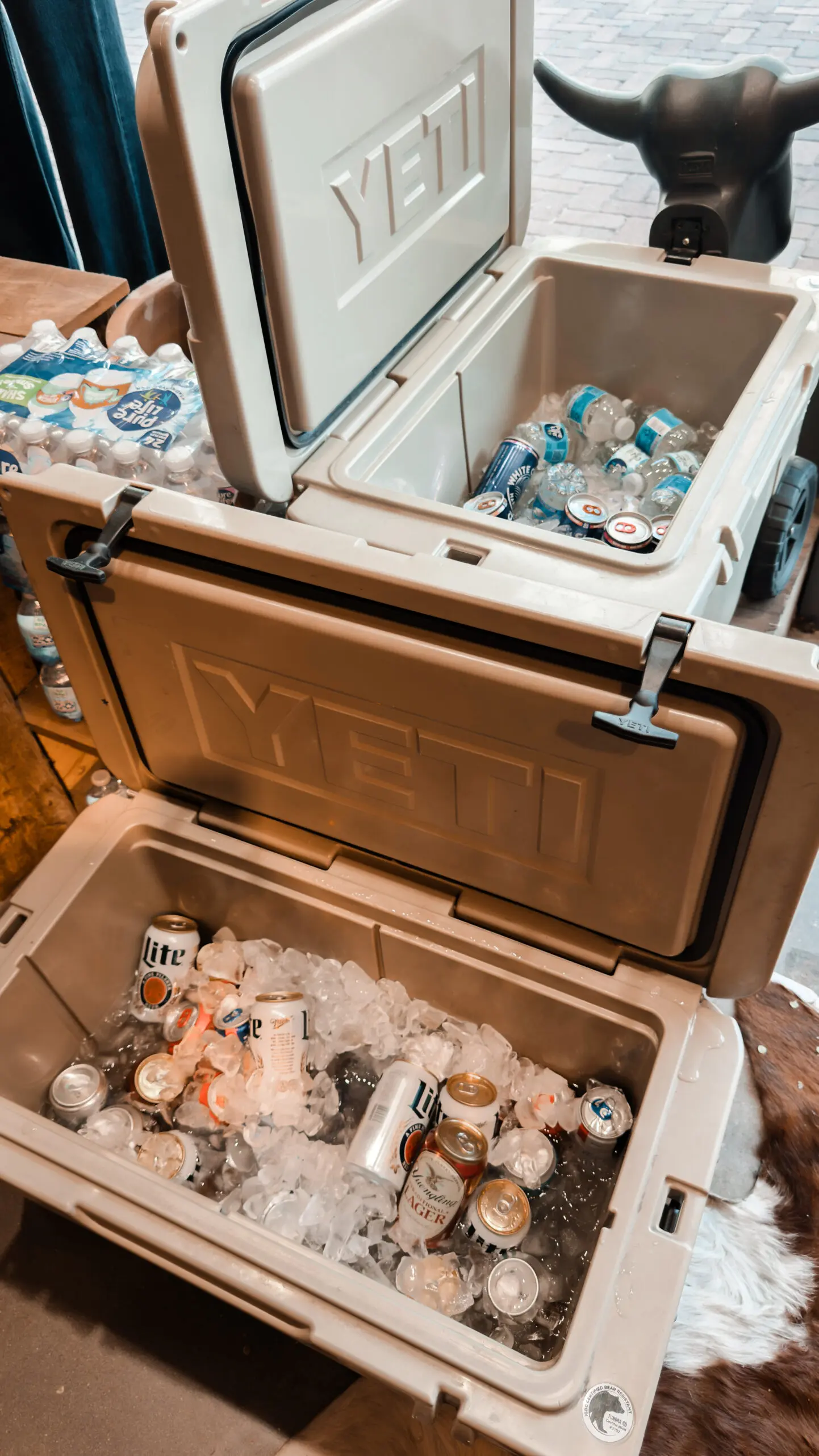 woman with a bob haircut holding a camera up to her face with a light in the background