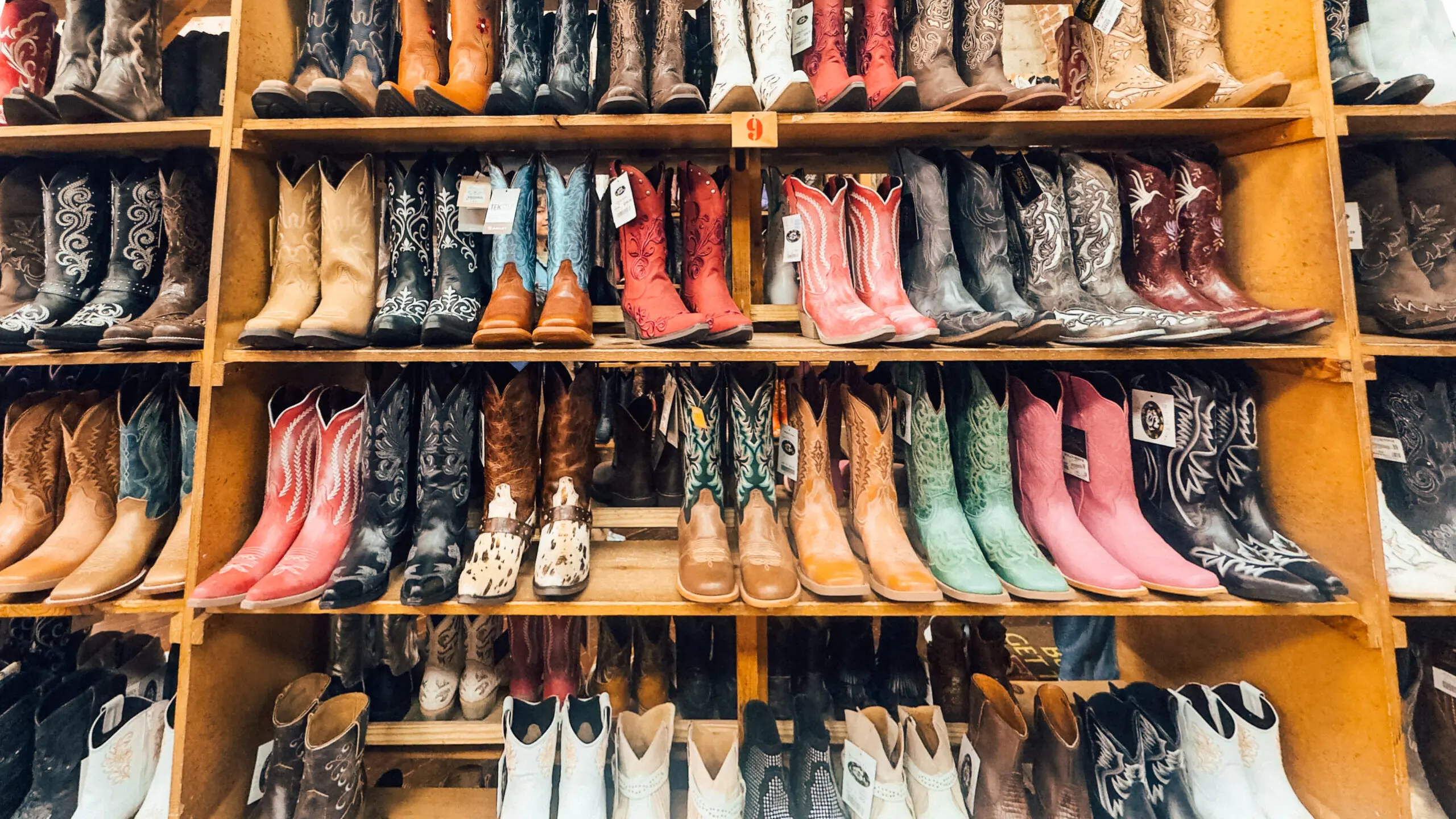 woman with a bob haircut holding a camera up to her face with a light in the background