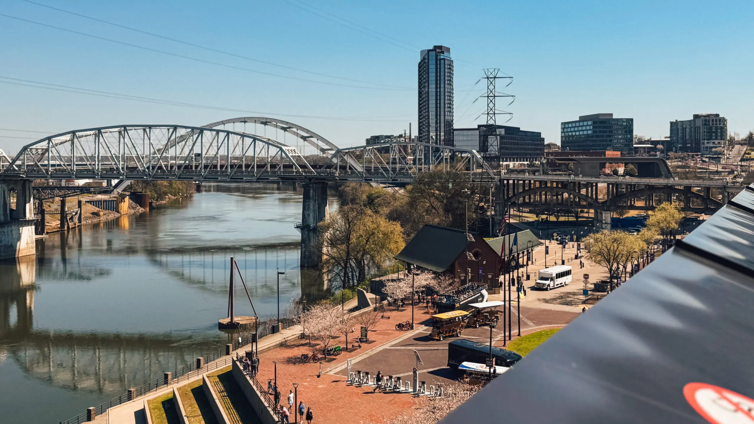 woman with a bob haircut holding a camera up to her face with a light in the background
