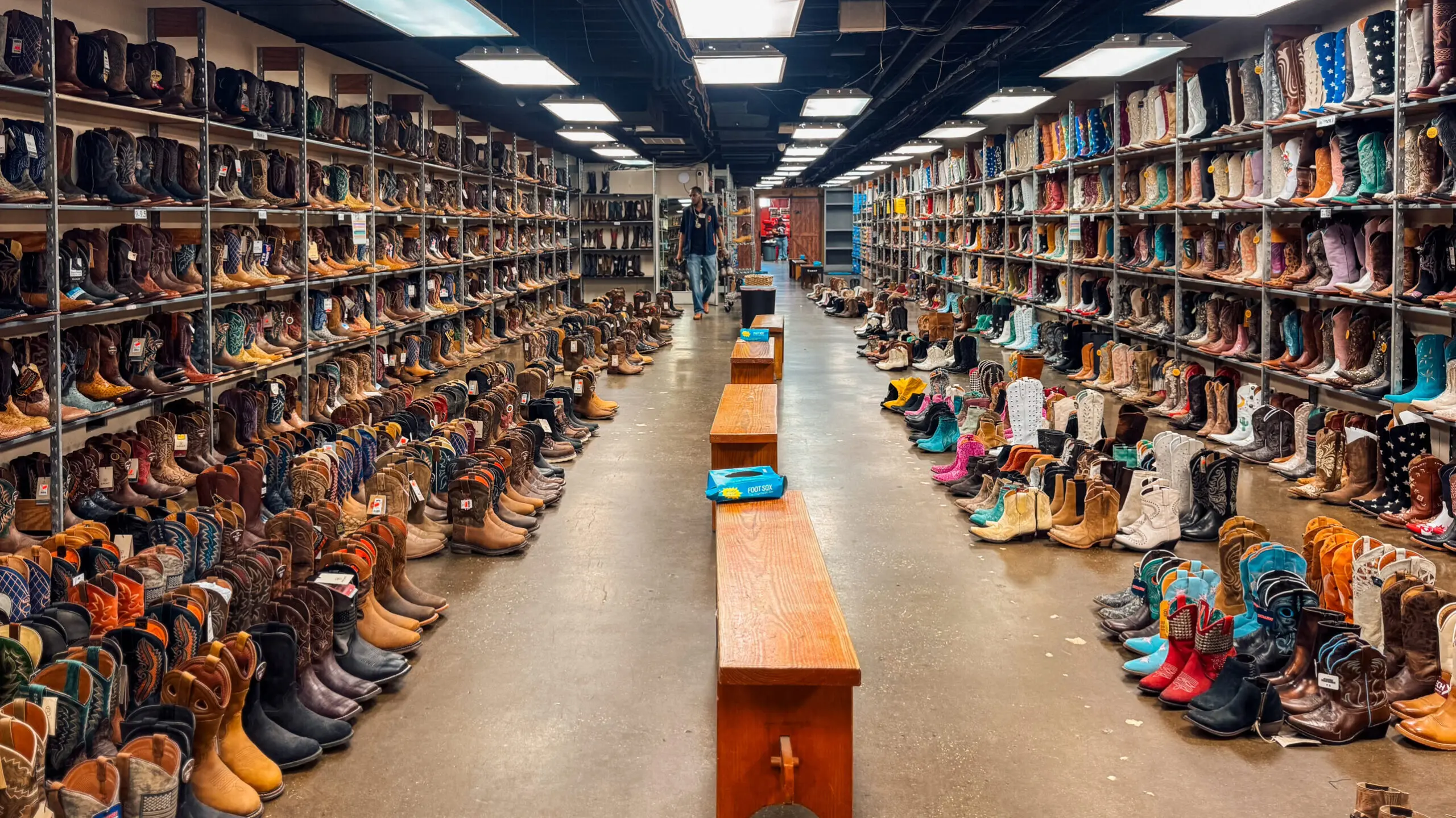 woman with a bob haircut holding a camera up to her face with a light in the background