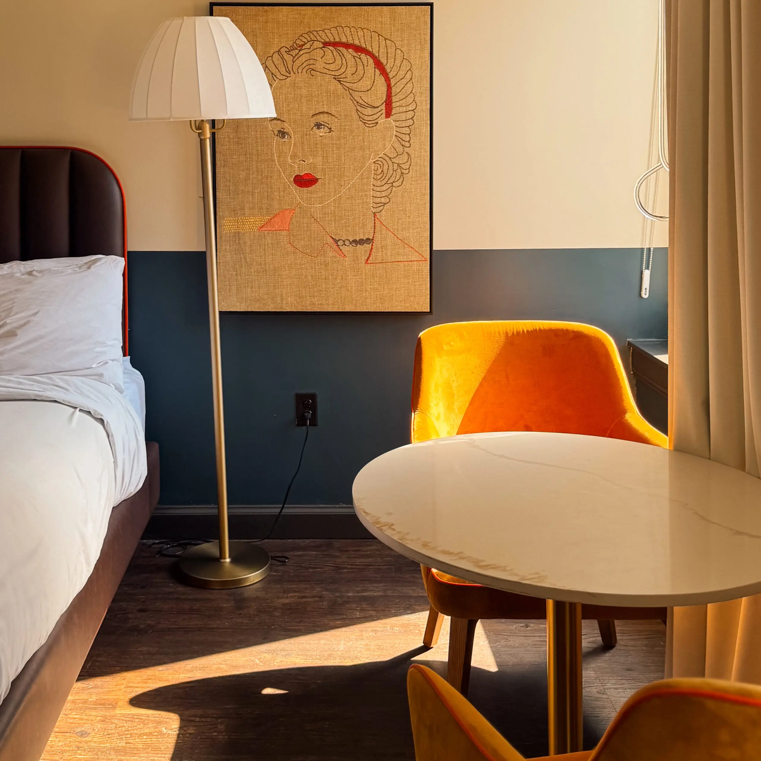 woman with a bob haircut holding a camera up to her face with a light in the background