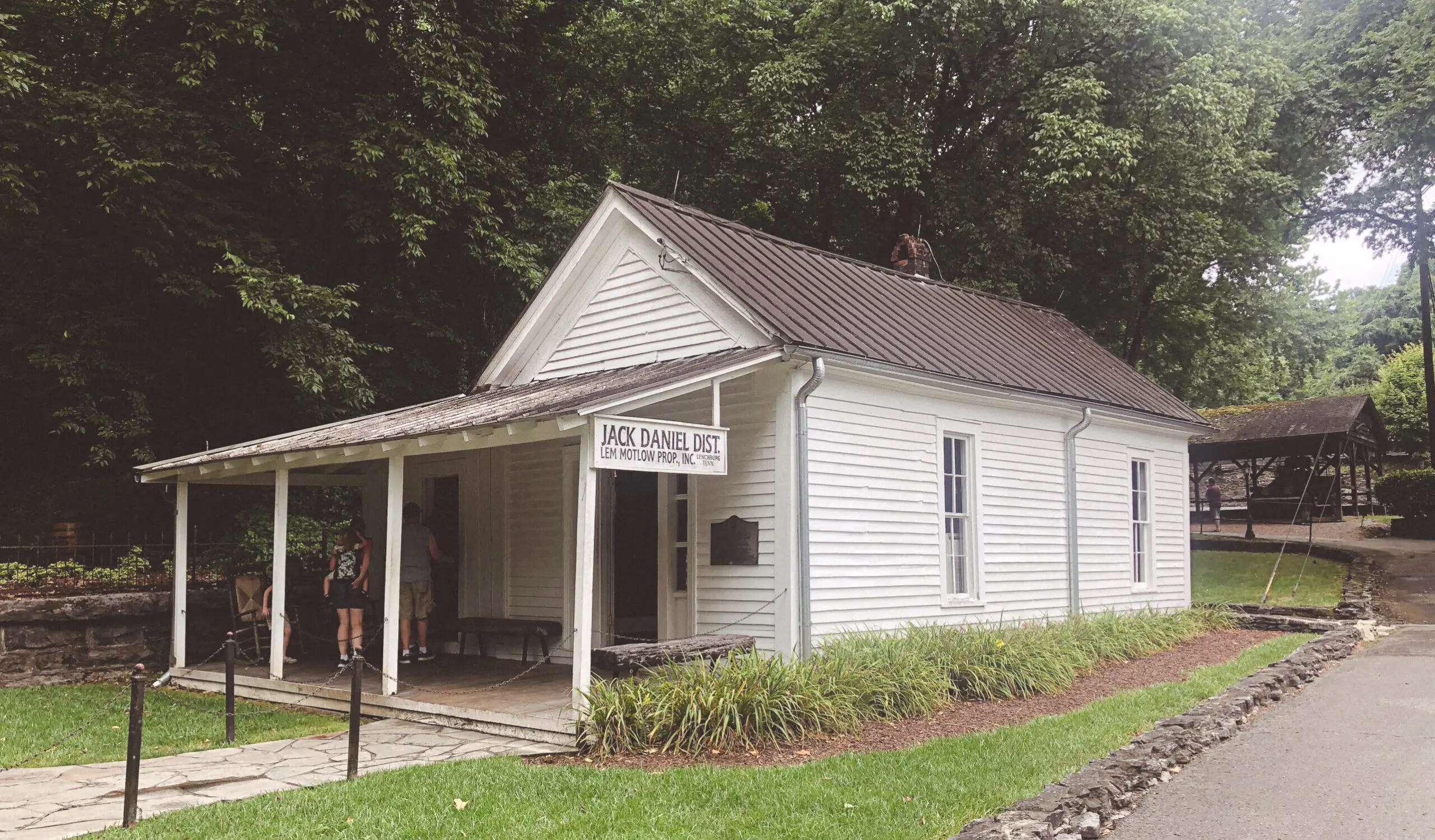 woman with a bob haircut holding a camera up to her face with a light in the background