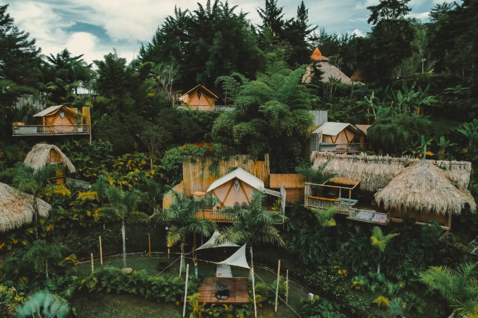 woman with a bob haircut holding a camera up to her face with a light in the background