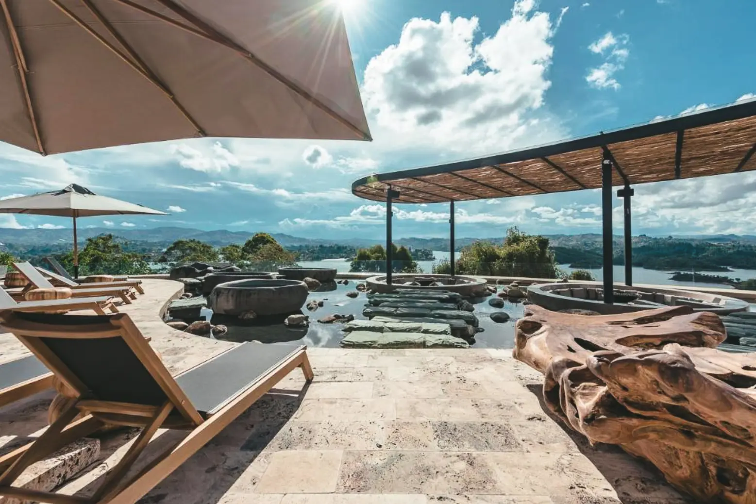 woman with a bob haircut holding a camera up to her face with a light in the background