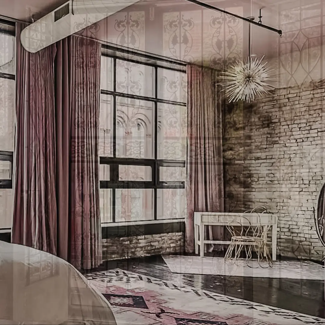 woman with a bob haircut holding a camera up to her face with a light in the background