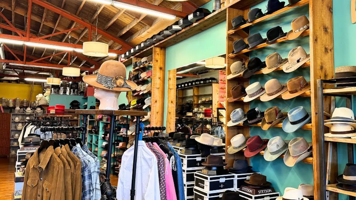 woman with a bob haircut holding a camera up to her face with a light in the background