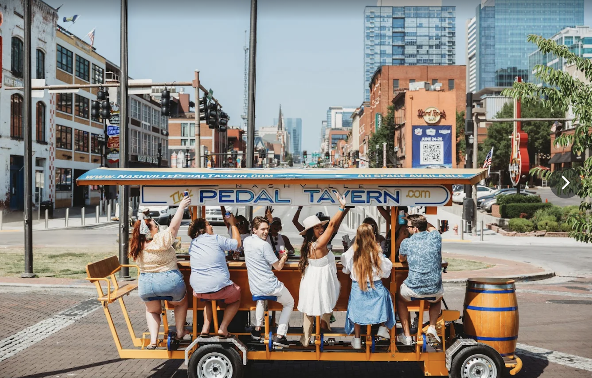 woman with a bob haircut holding a camera up to her face with a light in the background