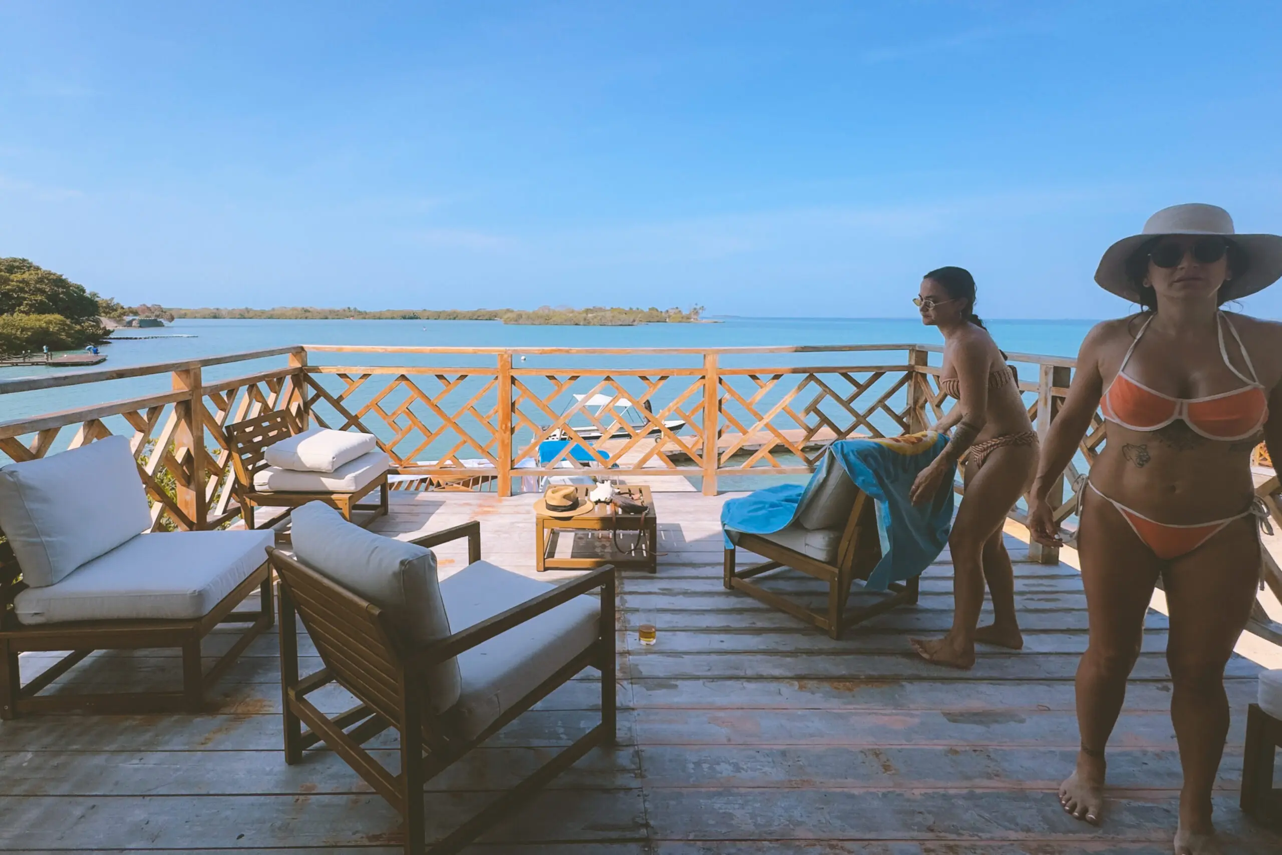 woman with a bob haircut holding a camera up to her face with a light in the background