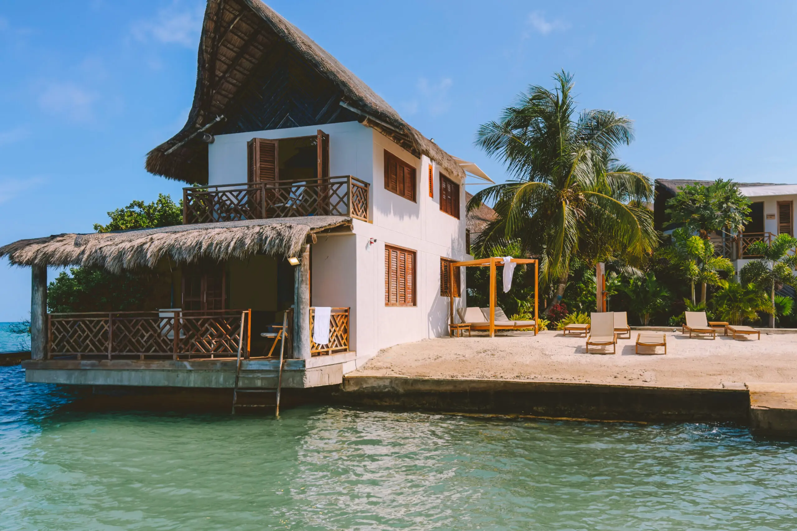 woman with a bob haircut holding a camera up to her face with a light in the background