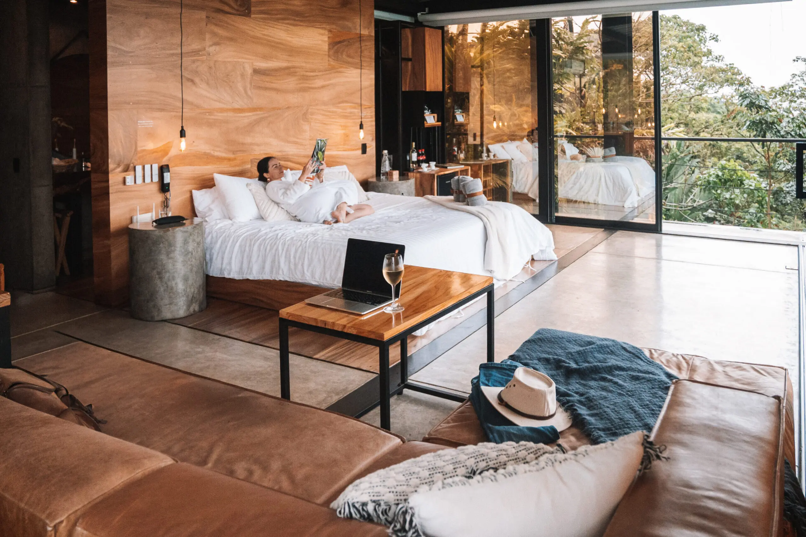 Cozy modern bedroom with natural wood and large windows.