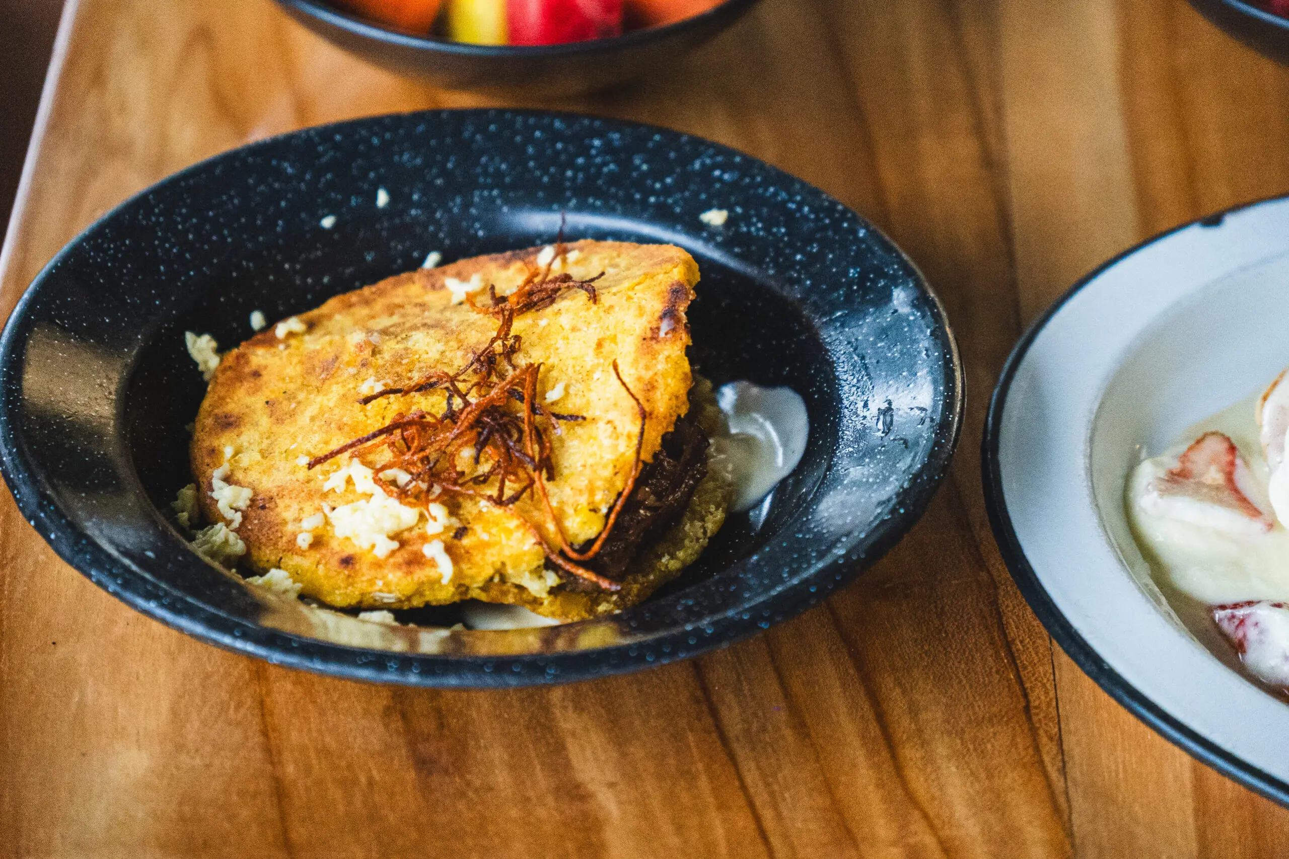 Delicious golden-brown grilled chicken served on a black plate.