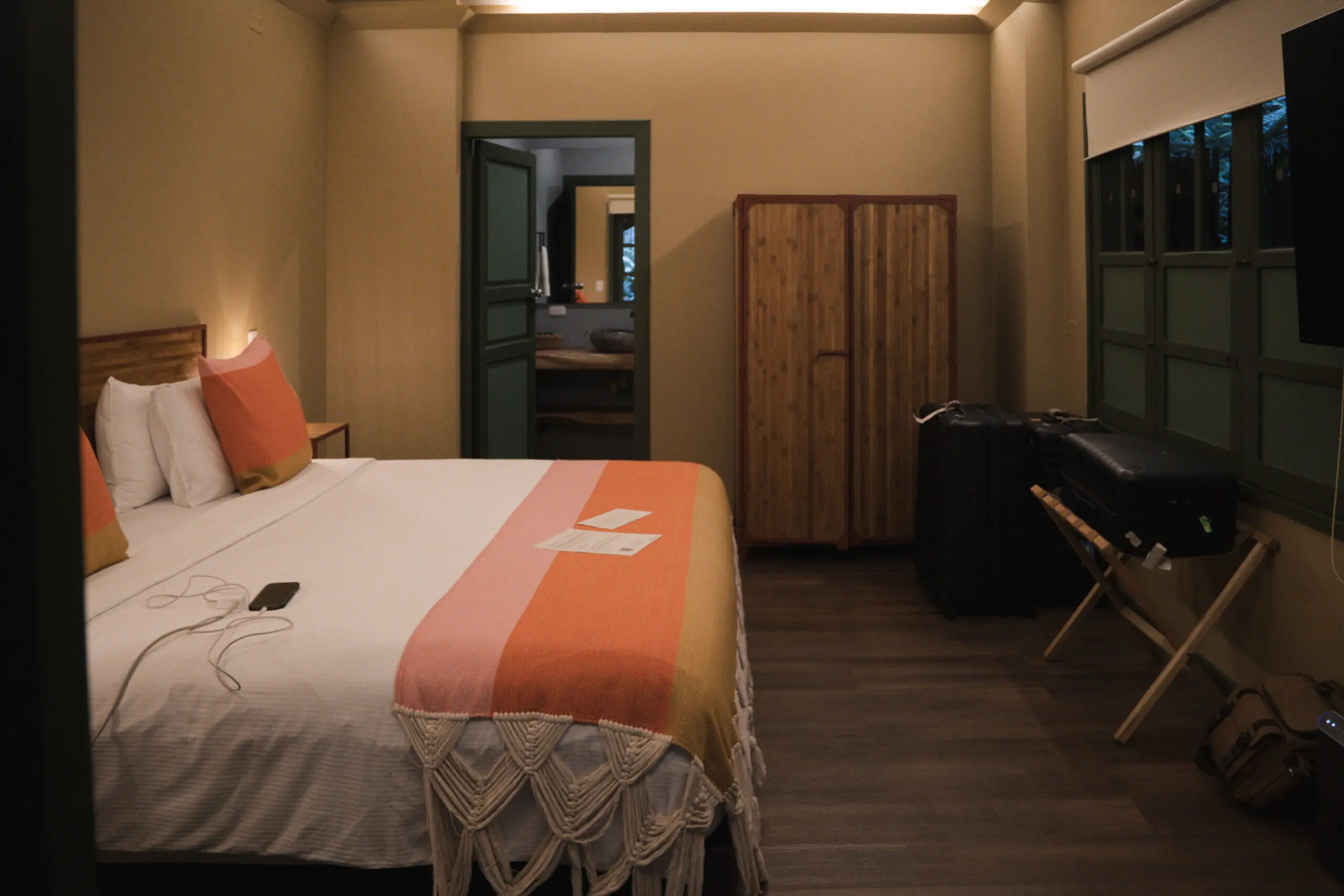 Cozy bedroom with warm lighting and rustic decor.