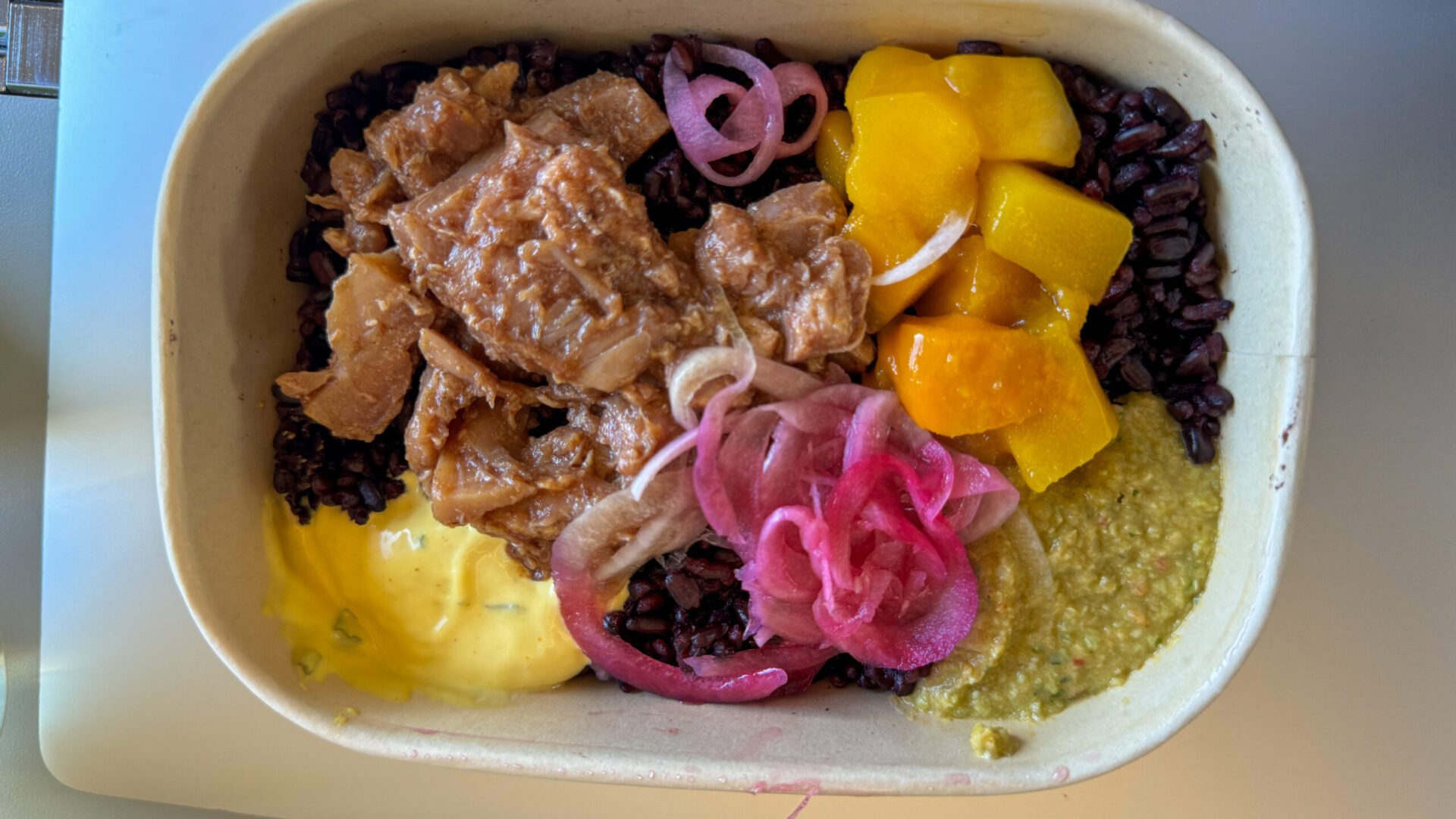 “Kycklingbowl”, which is Swedish for “chicken bowl.” Made with BBQ-marinated Bjäre chicken, black rice, mango dressing in a paper bowl