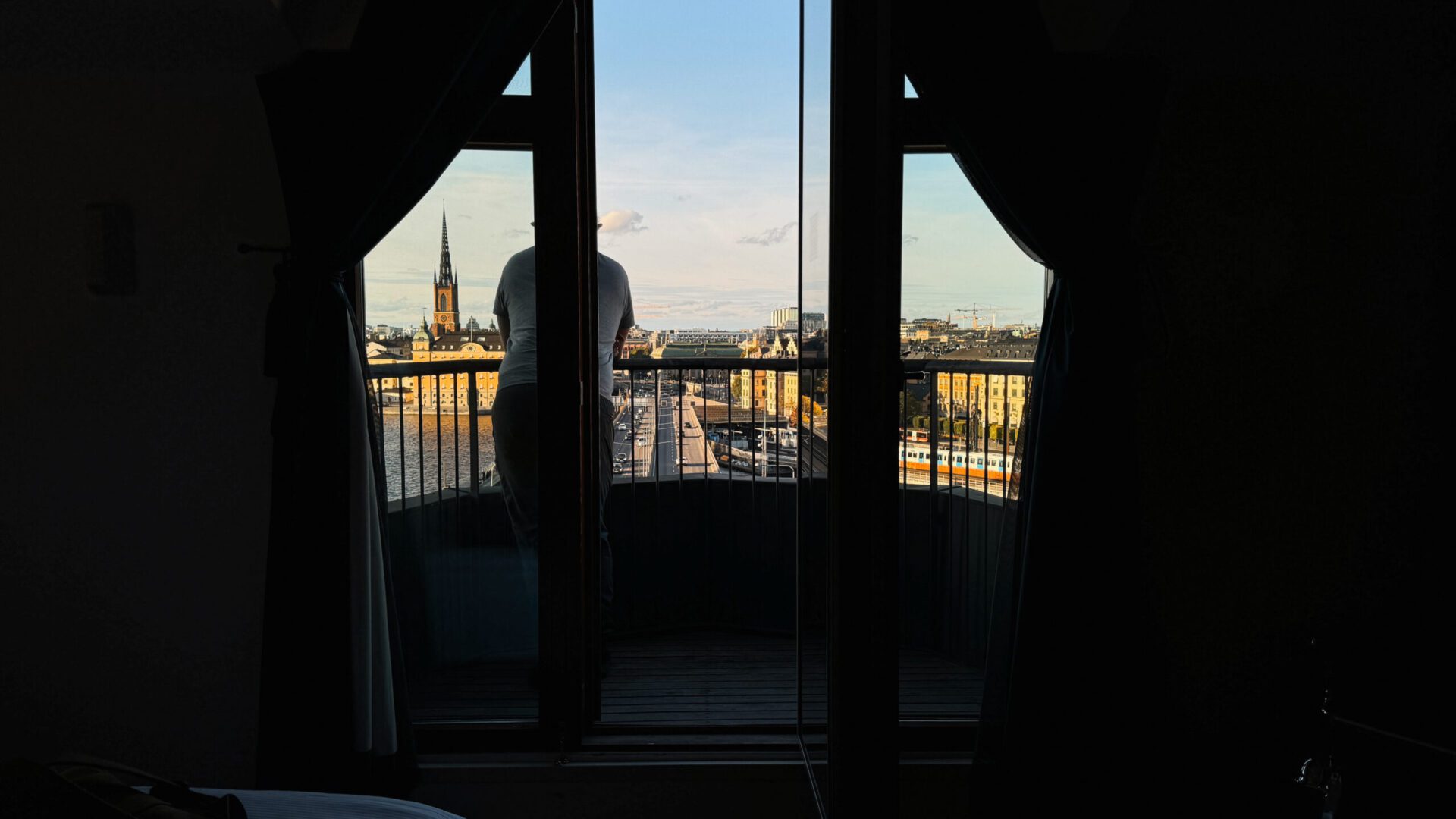 Man standing on a hotel balcony looking over Stockholm